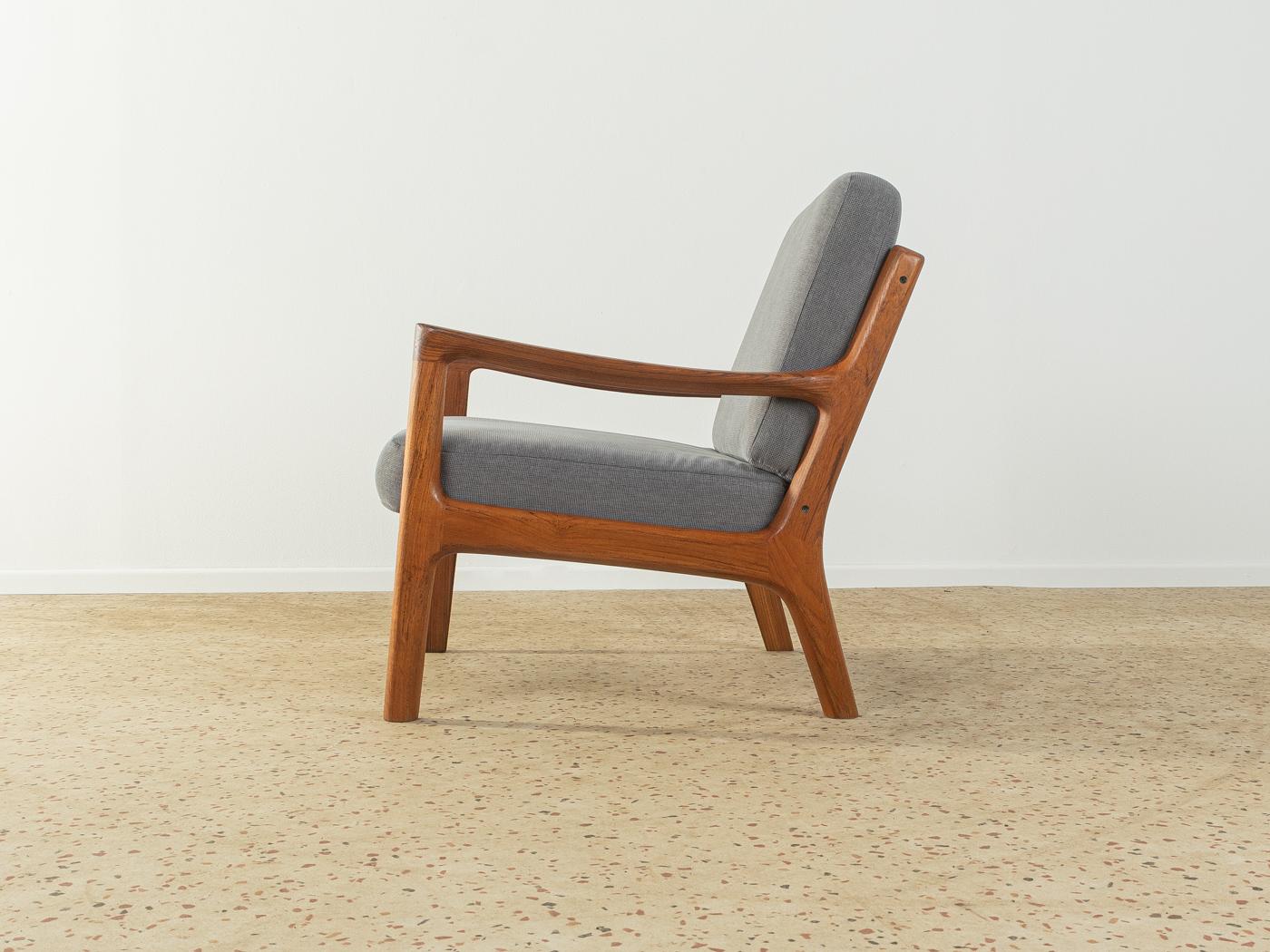 Classic armchair from the 1960s. Model Senator by Ole Wanscher for Cado. High-quality solid teak frame. The original spring core has been reupholstered and covered with a high-quality fabric in grey.

Quality Features:
 accomplished design: