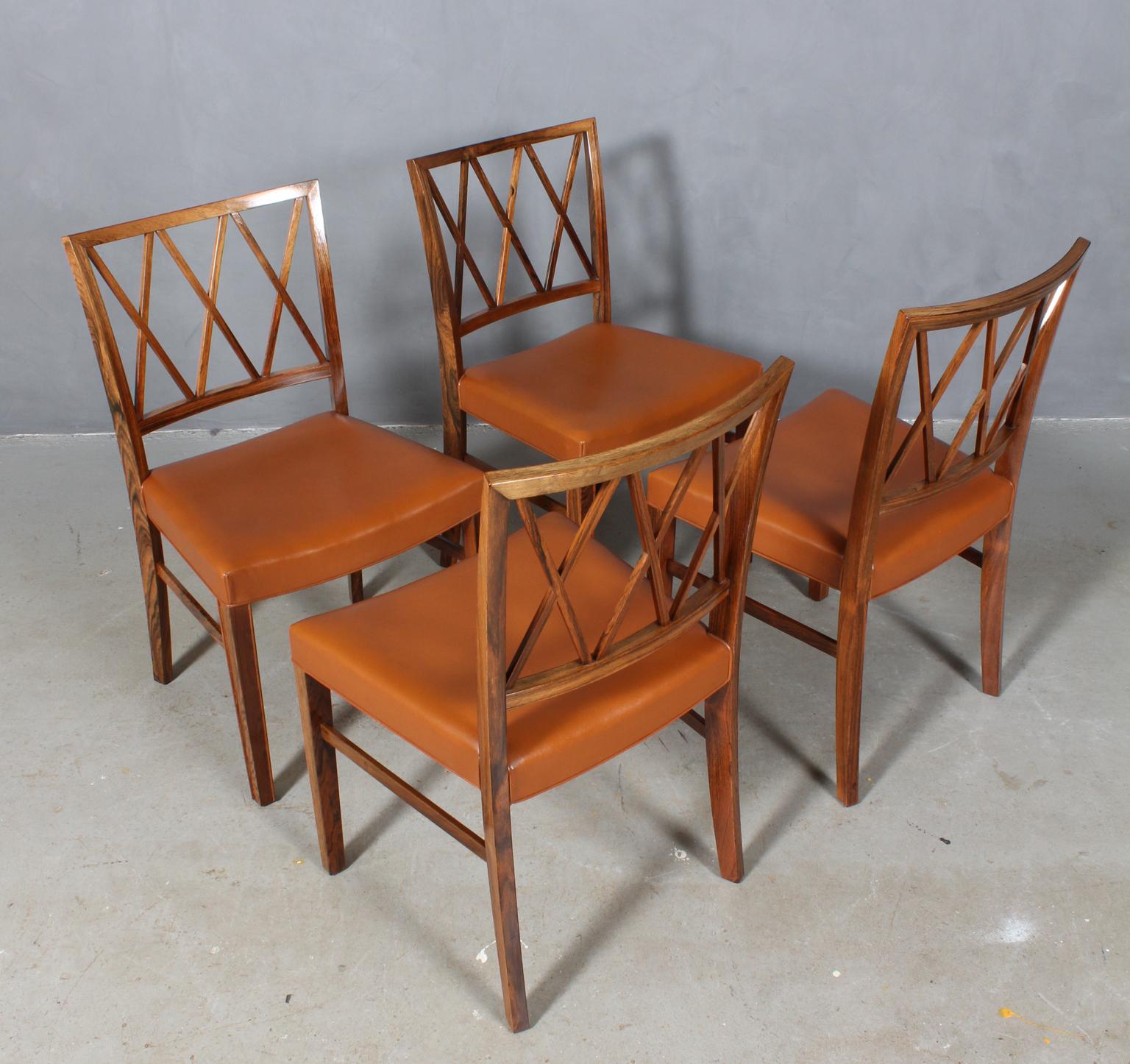 Ole Wanscher set of four dining chairs, upholstered with light patinated cognac aniline leather.

Made of rosewood, profilated legs.

Made of A. J. Iversen.