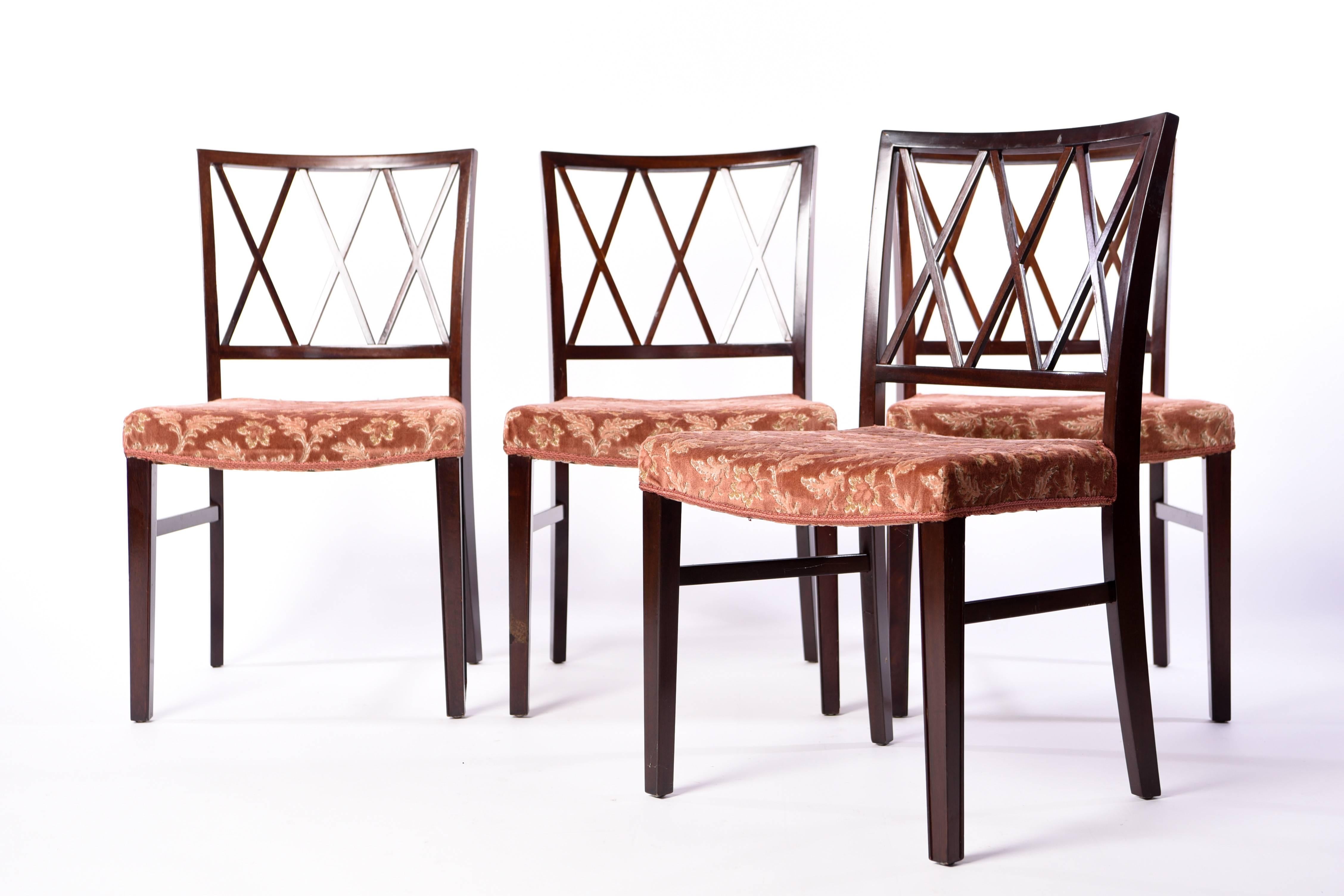 This set of four chairs was designed by Ole Wanscher in 1942, and executed by A. J. Iversen, Denmark. Featuring well crafted frames of mahogany with a more traditional design.