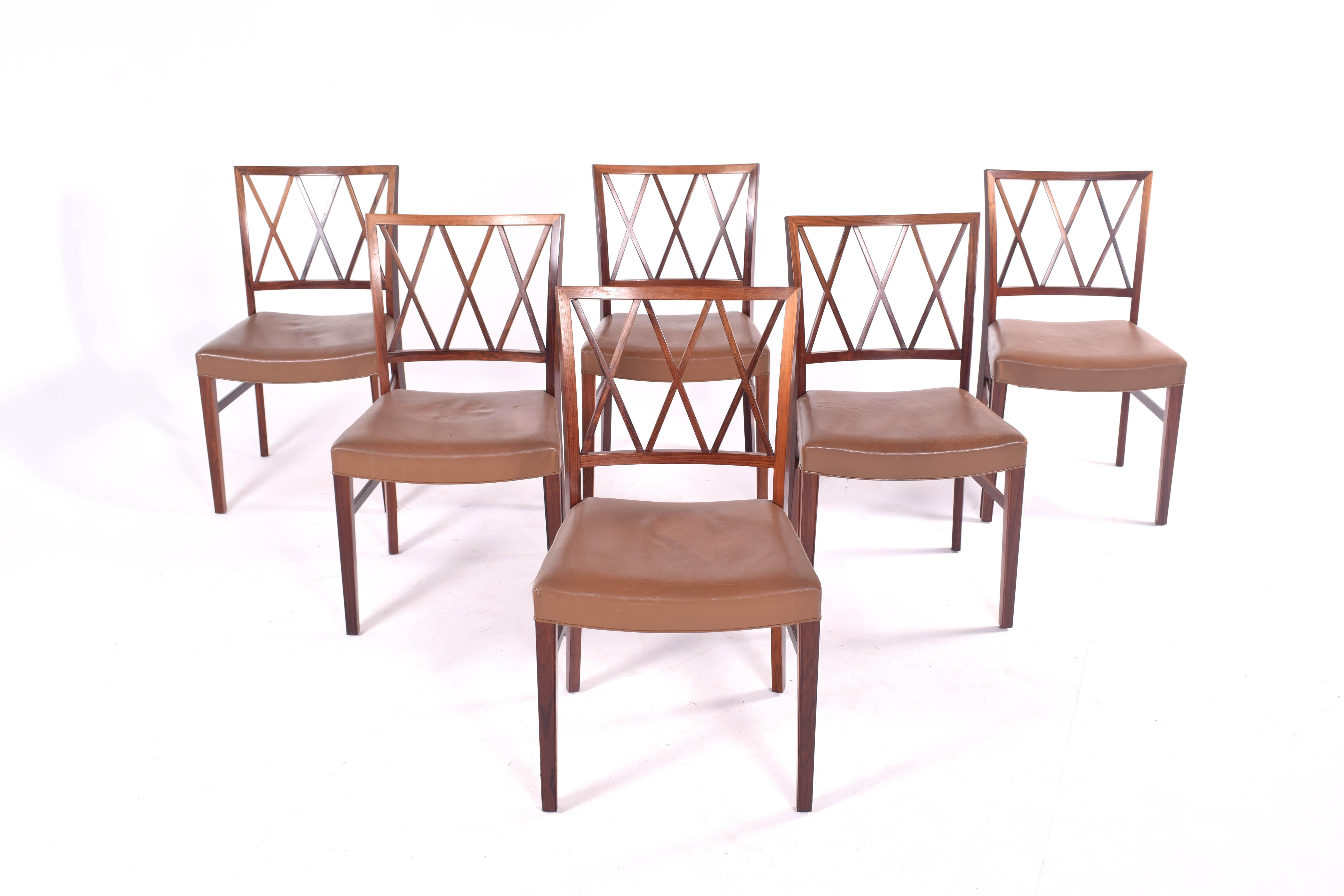 A set of 6 rosewood dining chairs by Ole Wanscher for Slagelse. This is one of Wanscher's classic designs. The frames are constructed of rosewood.