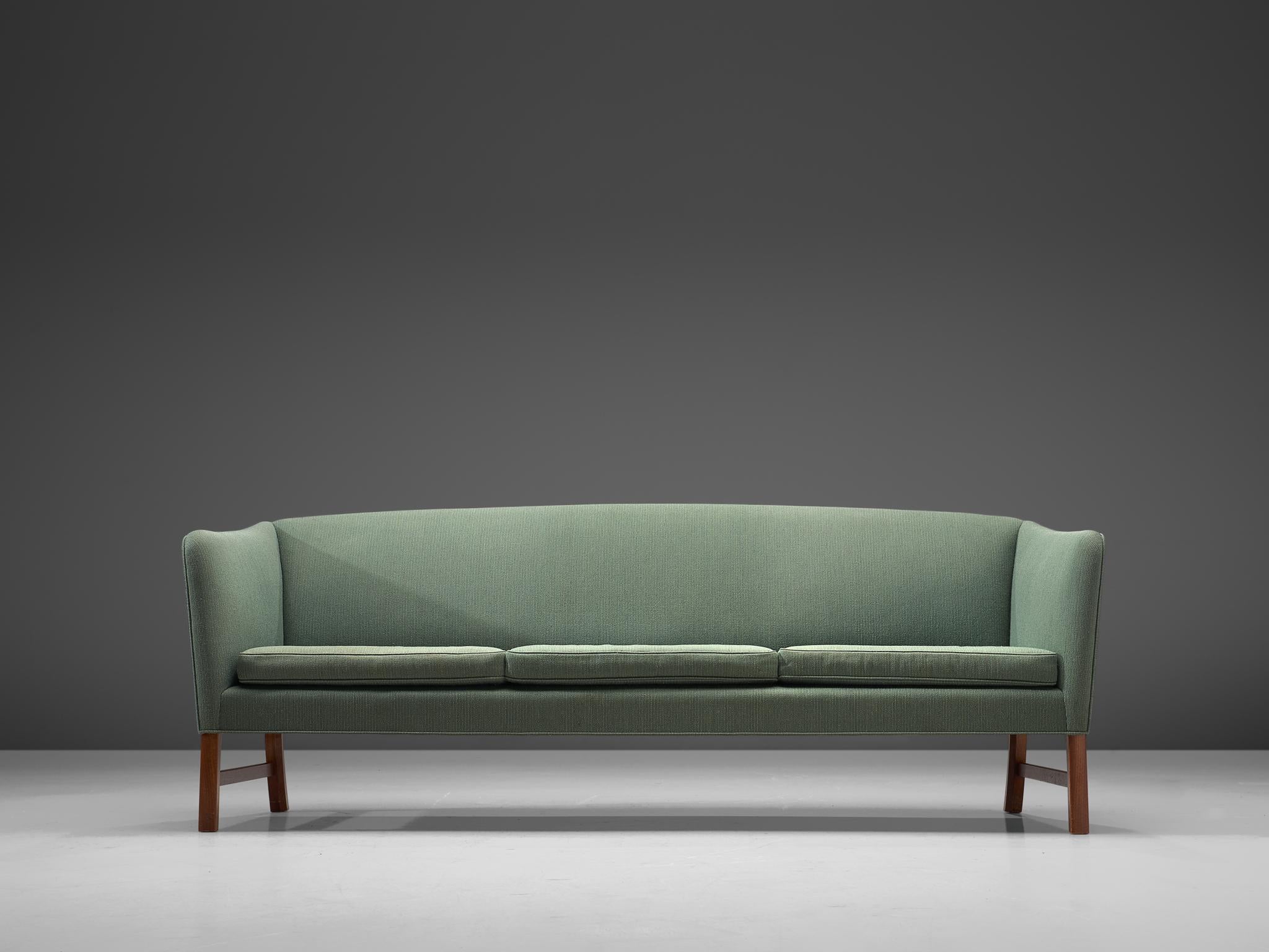 Ole Wanscher for A.J. Iversen, three-seat sofa, in mahogany and soft green fabric, Denmark, 1950s. 

This sofa is designed by Ole Wanscher for A.J. Iversen in the 1950s. Typical Danish design traits are shown, such as exquisite craftsmanship and
