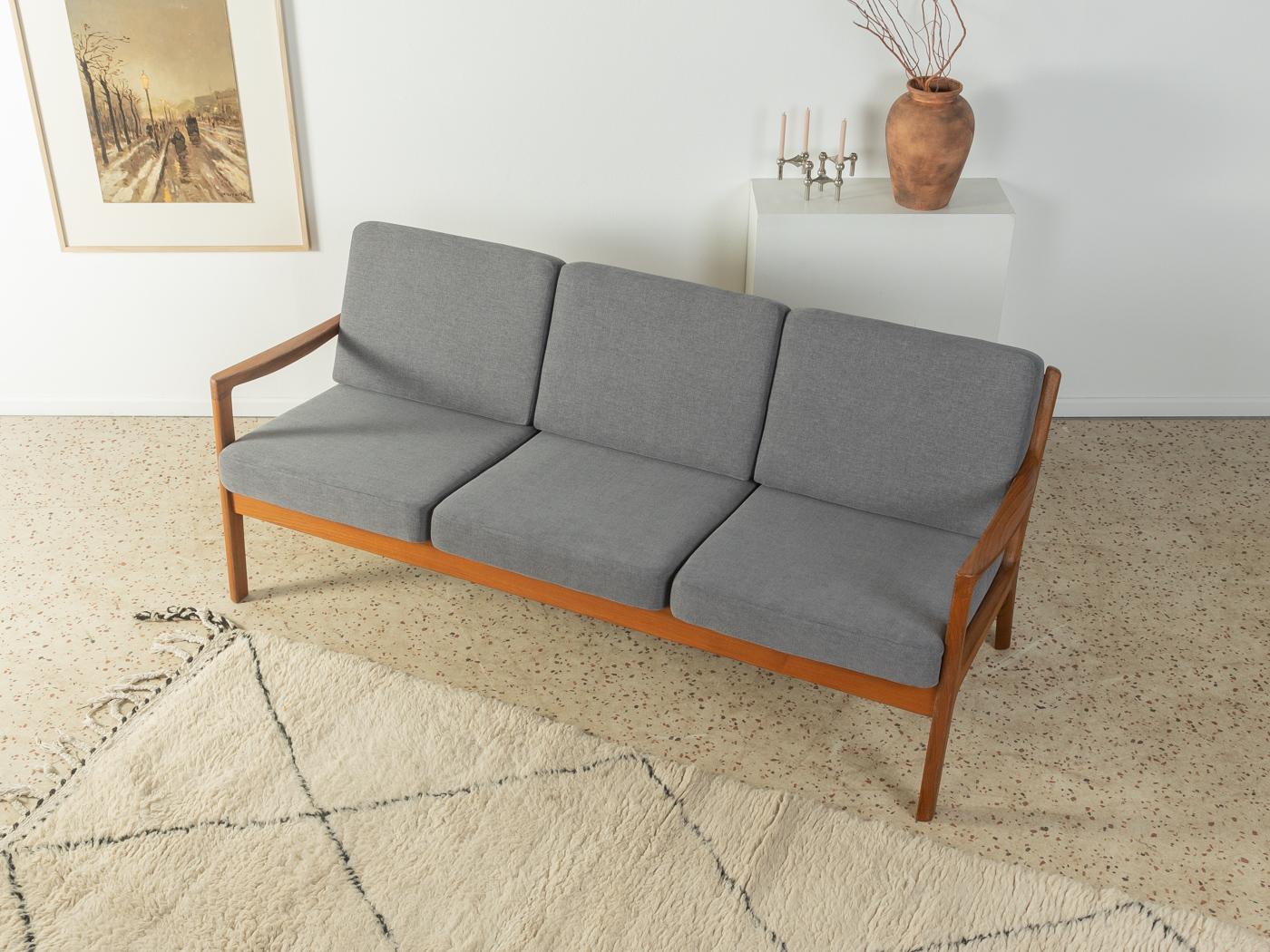 Classic 3-seater-sofa from the 1960s. Model Senator by Ole Wanscher for CADO. High-quality solid teak frame. The sofa has been reupholstered and covered with a high-quality gray upholstery fabric.

Quality Features:
 accomplished design: perfect