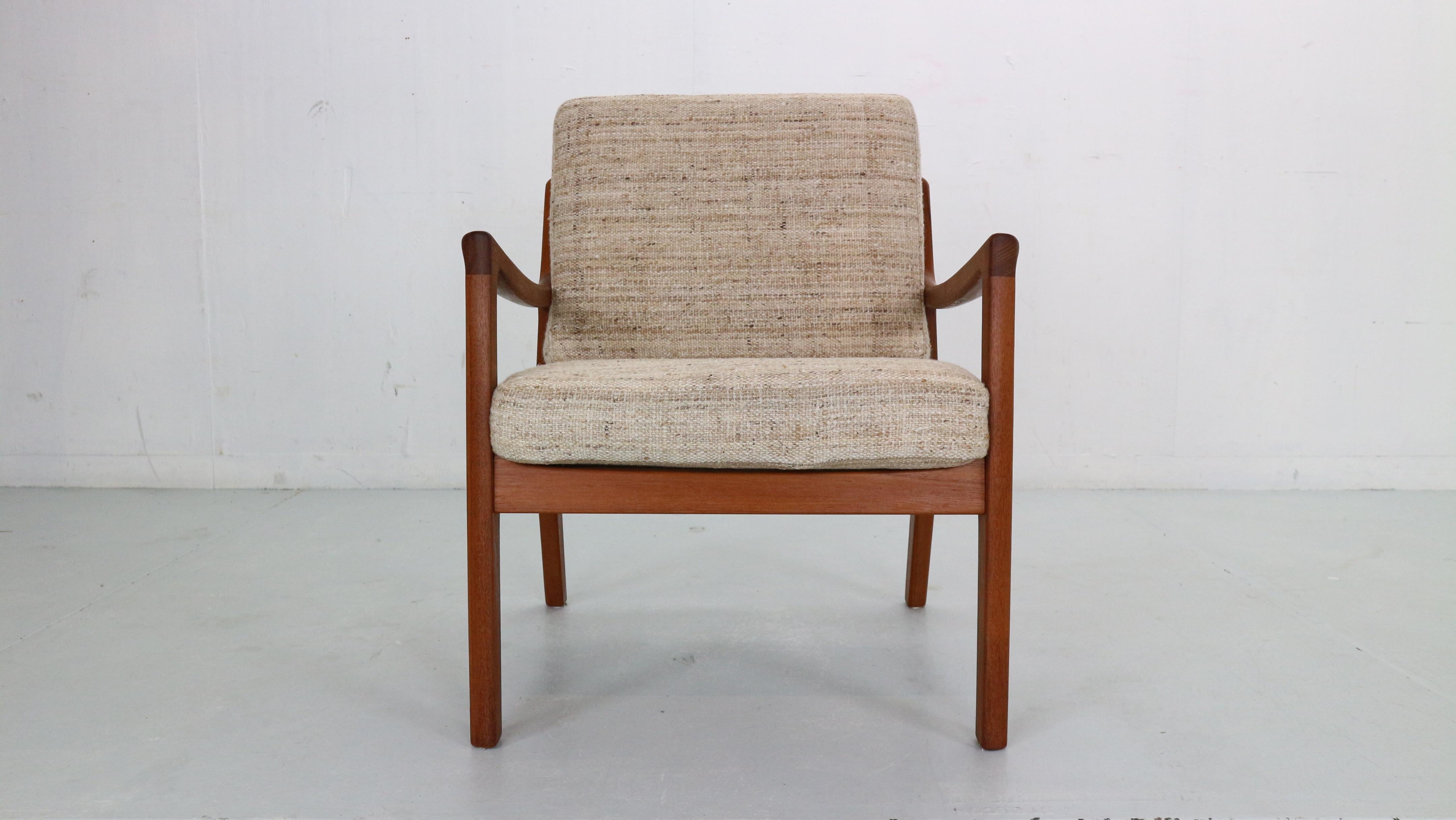 Elegant lounge chair designed by Ole Wanscher for France & Søn in Denmark, 1956.
This vintage model FD-109 lounge chair maintains the manufacturer’s mark and features a sturdy teak wood frame with a slated open back and angled legs for an organic