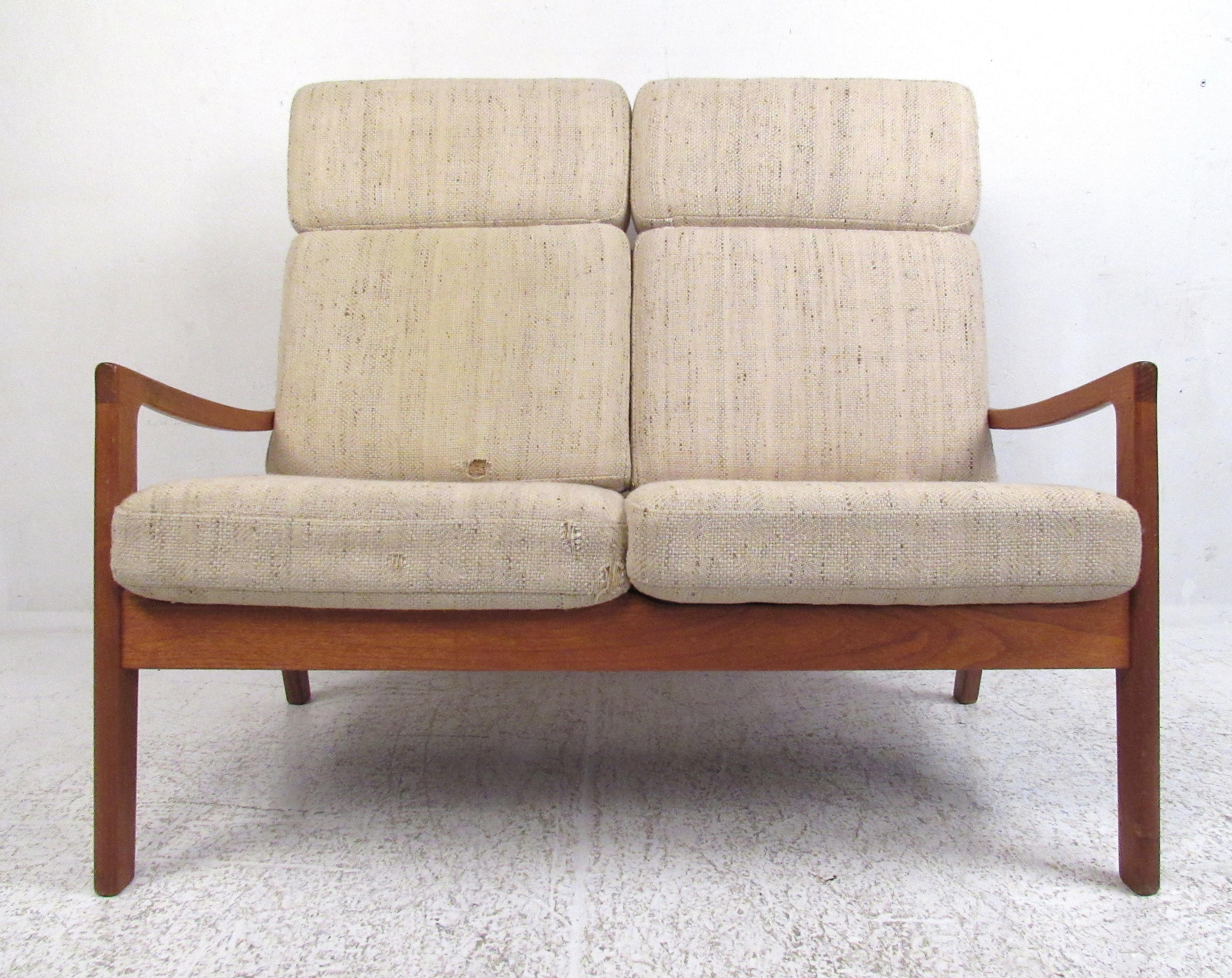 This teak high-back two-seat sofa was designed by Ole Wanscher as part of his 'Senator' line, circa 1960s. Please confirm item location (NY or NJ) with dealer.