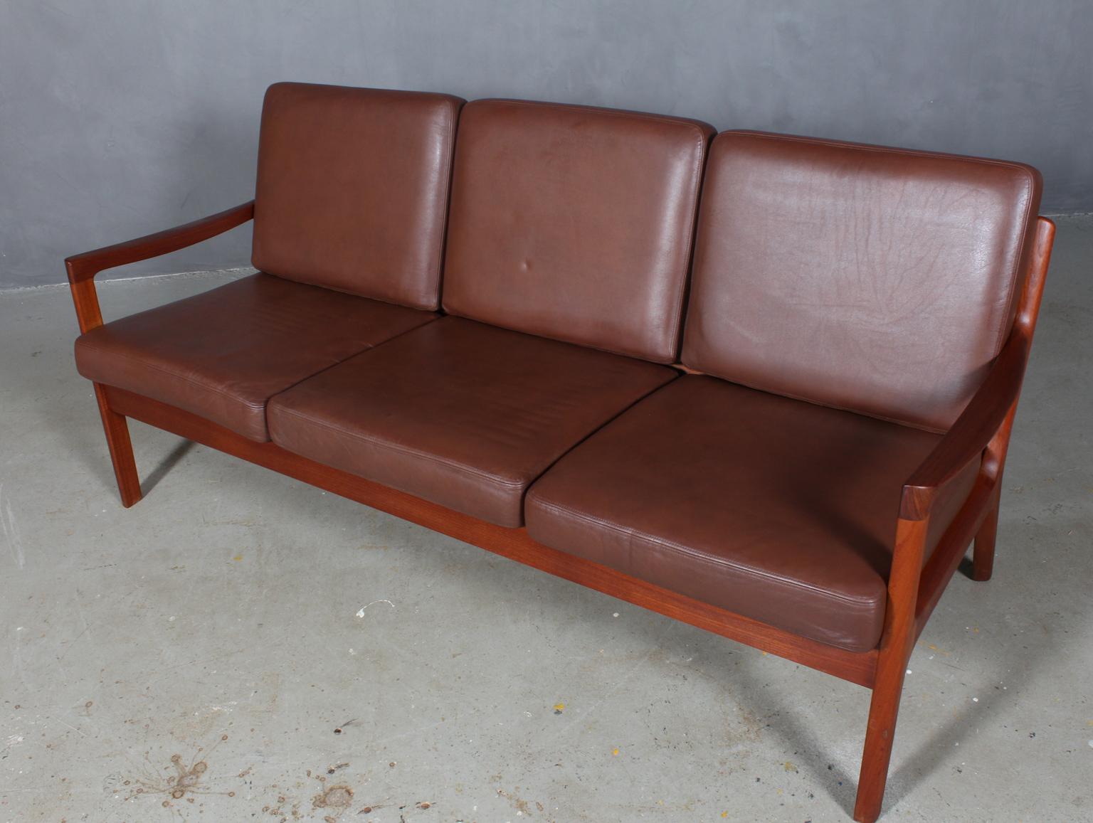Ole Wanscher three-seat sofa upholstered with light patinated brown leather.

Made of solid teak.

Model senator, made by Cado.
