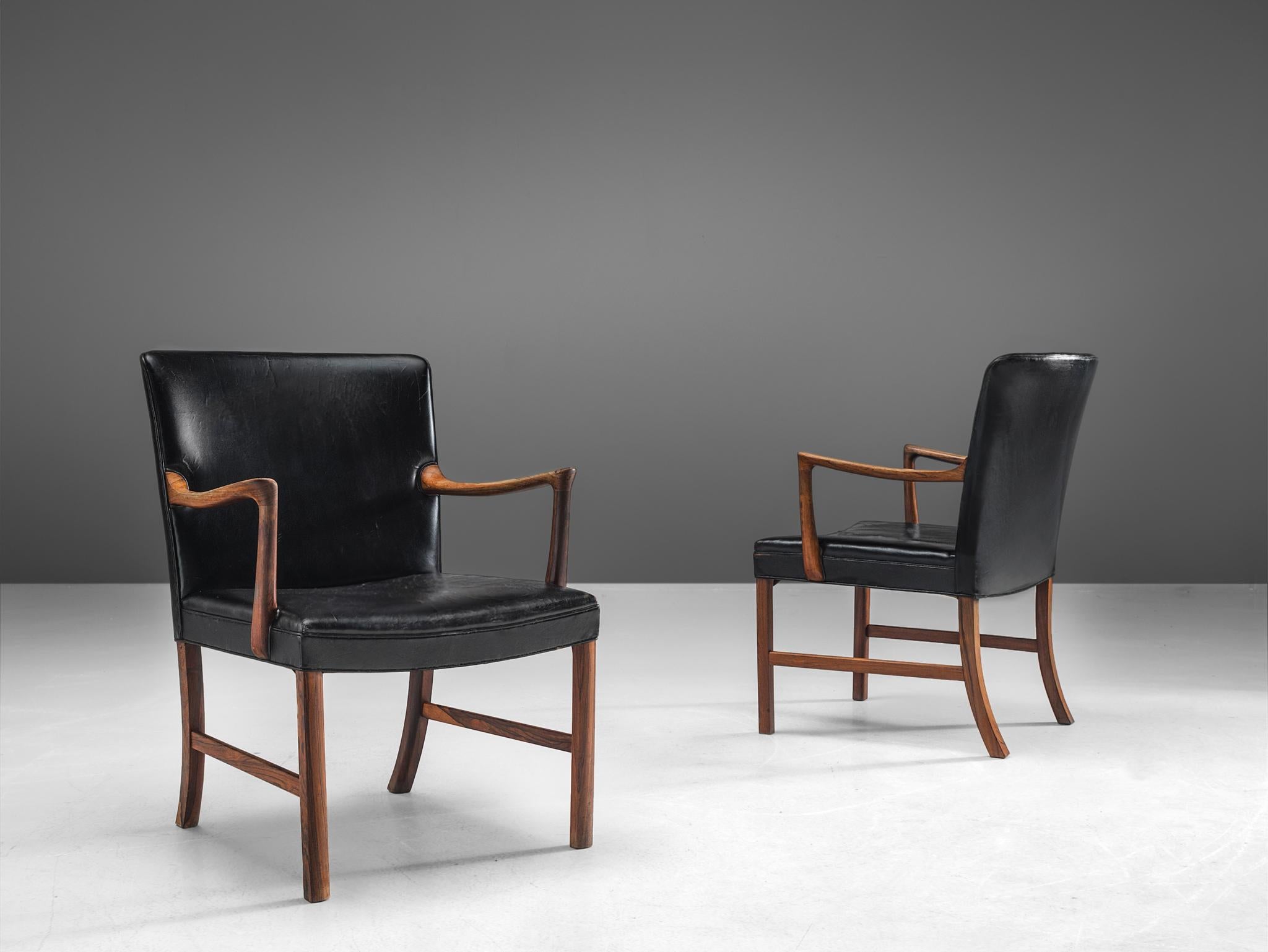 Ole Wanscher, two armchairs, armchairs, in rosewood and leather, Denmark, 1950s. 

This set of elegant easy chair in cognac leather and rosewood are designed by the Danish designer Ole Wanscher. The chairs are wide and highly comfortable. A true