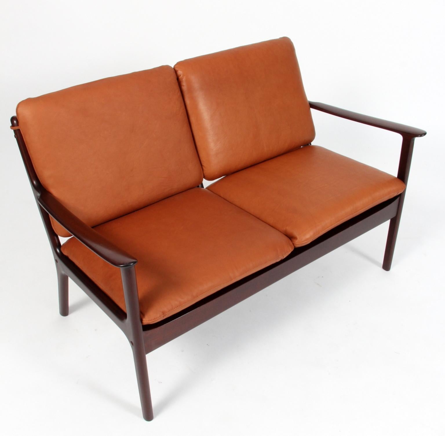 Ole Wanscher two-seat sofa new upholstered with cognac aniline leather.

Made of massive mahogany. 

Model PJ112, Poul Jeppesen.

 