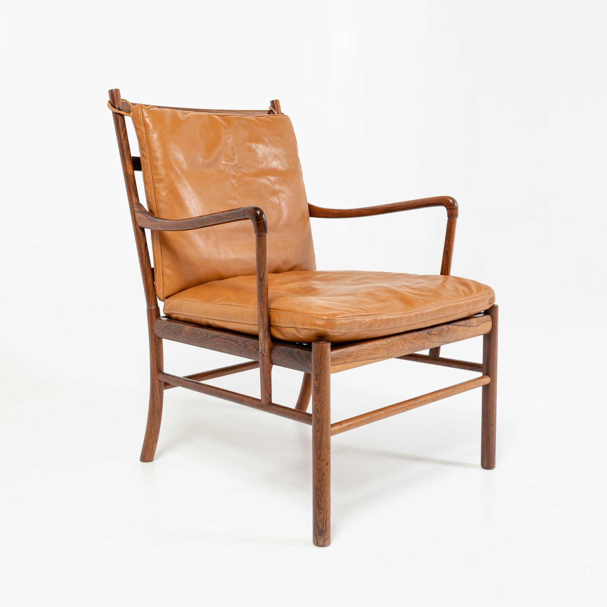 This is a rare and in exceptional condition Ole Wanscher's Colonial chair in Rosewood, with a new set of new Maharam Sorghum brown cushions. Poul Jeppesen in Denmark c1950s and distributed by Illums Bolighus with solid rosewood for the frame, cane
