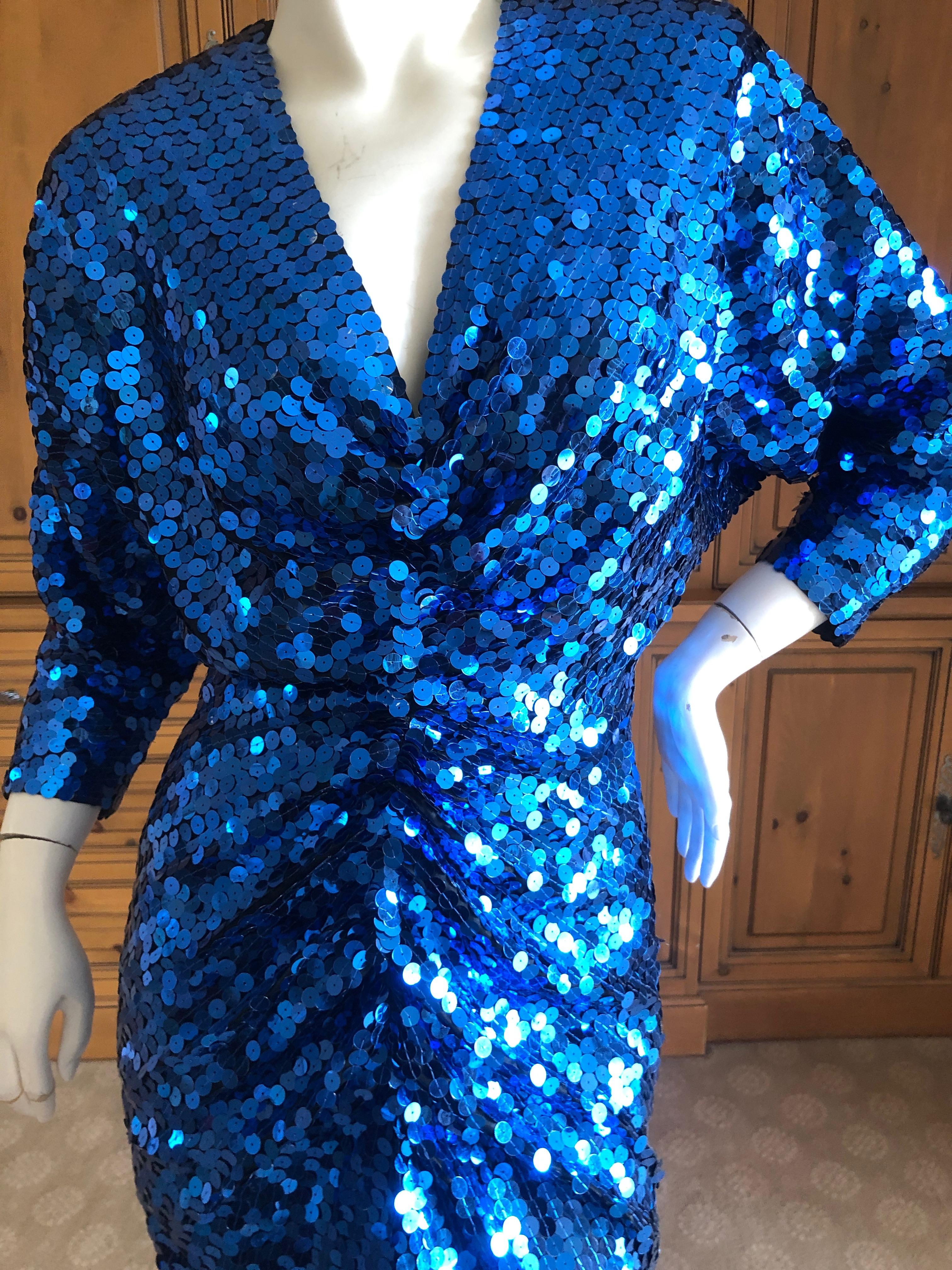 Oleg Cassini 1970's Sequin Disco Era Dress. New with tags
This is such a classic example of disco dressing, with a knot at the bust.
Vintage size 8
Bust 38