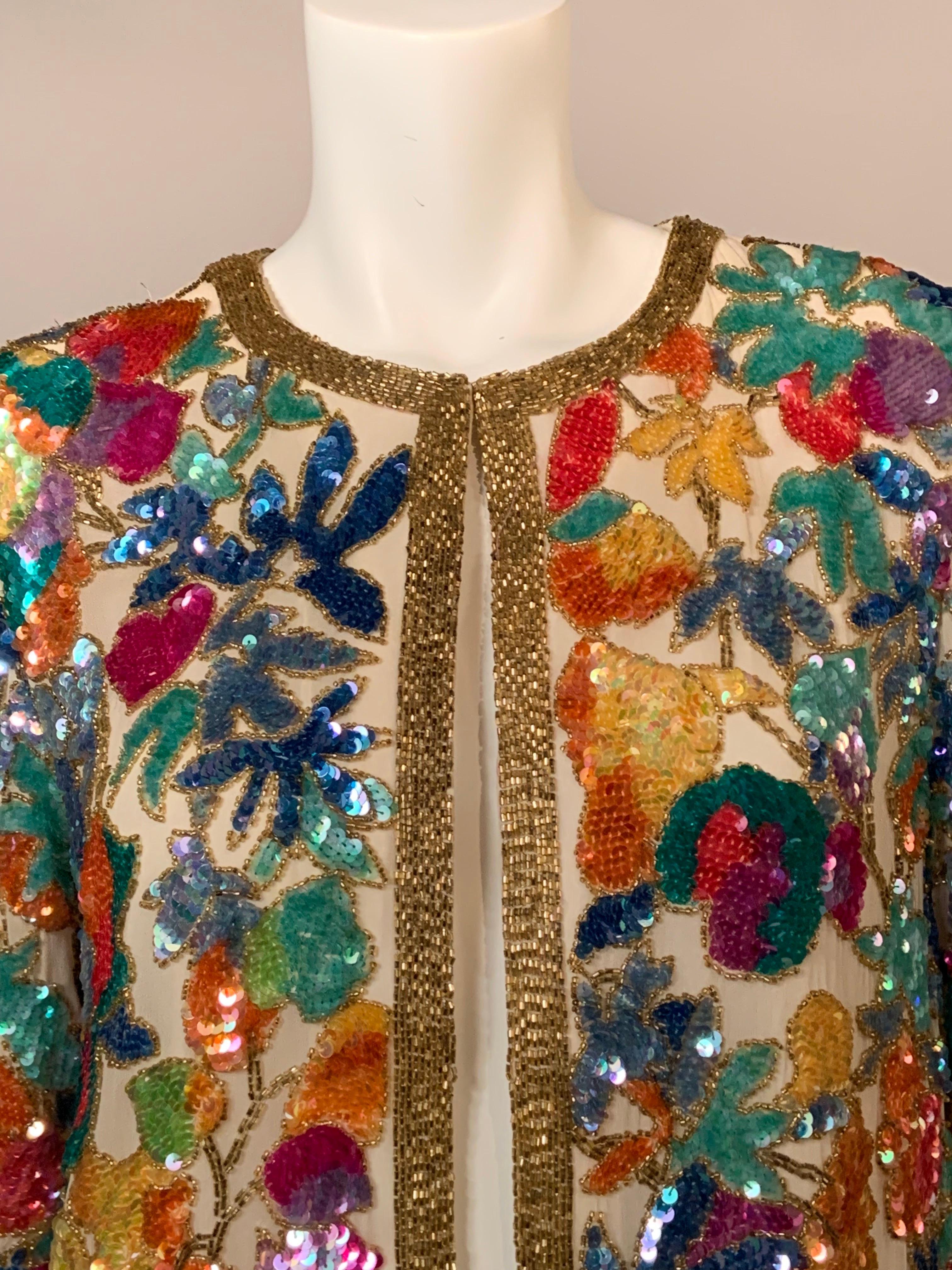 Oleg Cassini designed this beautiful beaded jacket using gold bugle beads to edge the floral design at the center front, neckline, cuffs and hemline.   The flowers on the body of the jacket are beaded with opalescent sequins which are all outlined