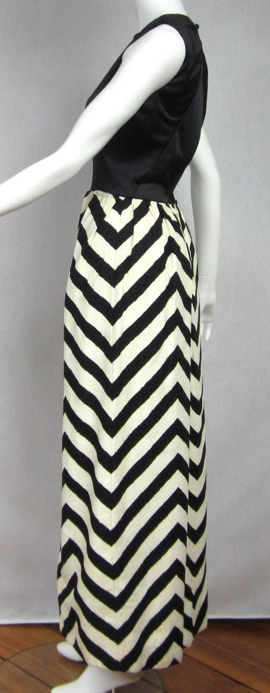 Maxi Dress by Oleg Cassini. Great Black and White Chevron Motif. Black Top, with sexy open back. Zippers up the skirt, clip shut at the waist and collar. The dress has Pockets. The Skirt is lined. Measurements are as follows, Bust 36 ** Waist 25 **