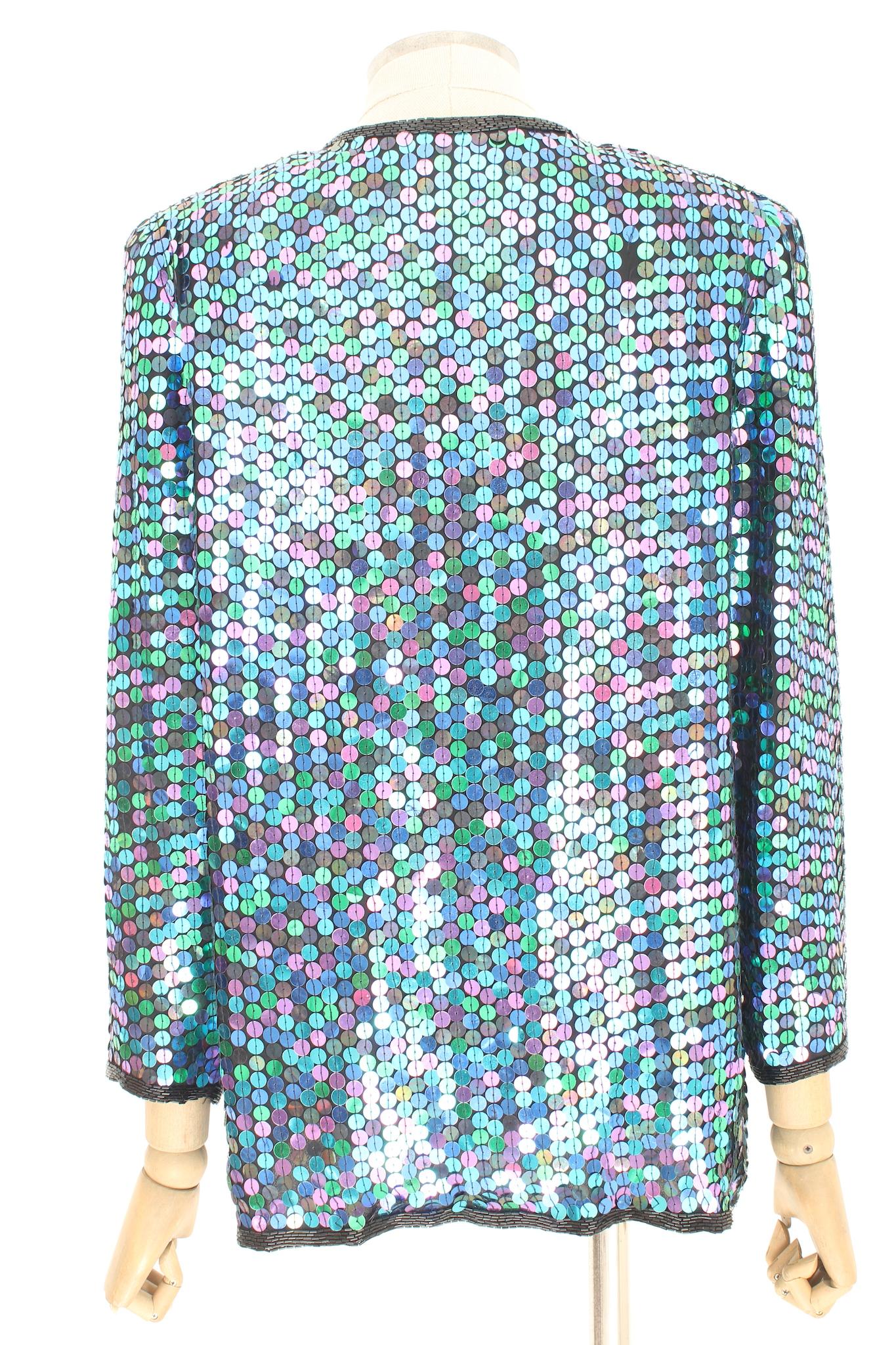 Oleg Cassini elegant vintage 90s jacket. Evening blazer covered in sequins in changing colors from green to pink, the edges are covered in black beads. Clip closure, shoulder straps sewn inside. 100% silk fabric. In some places sequins are