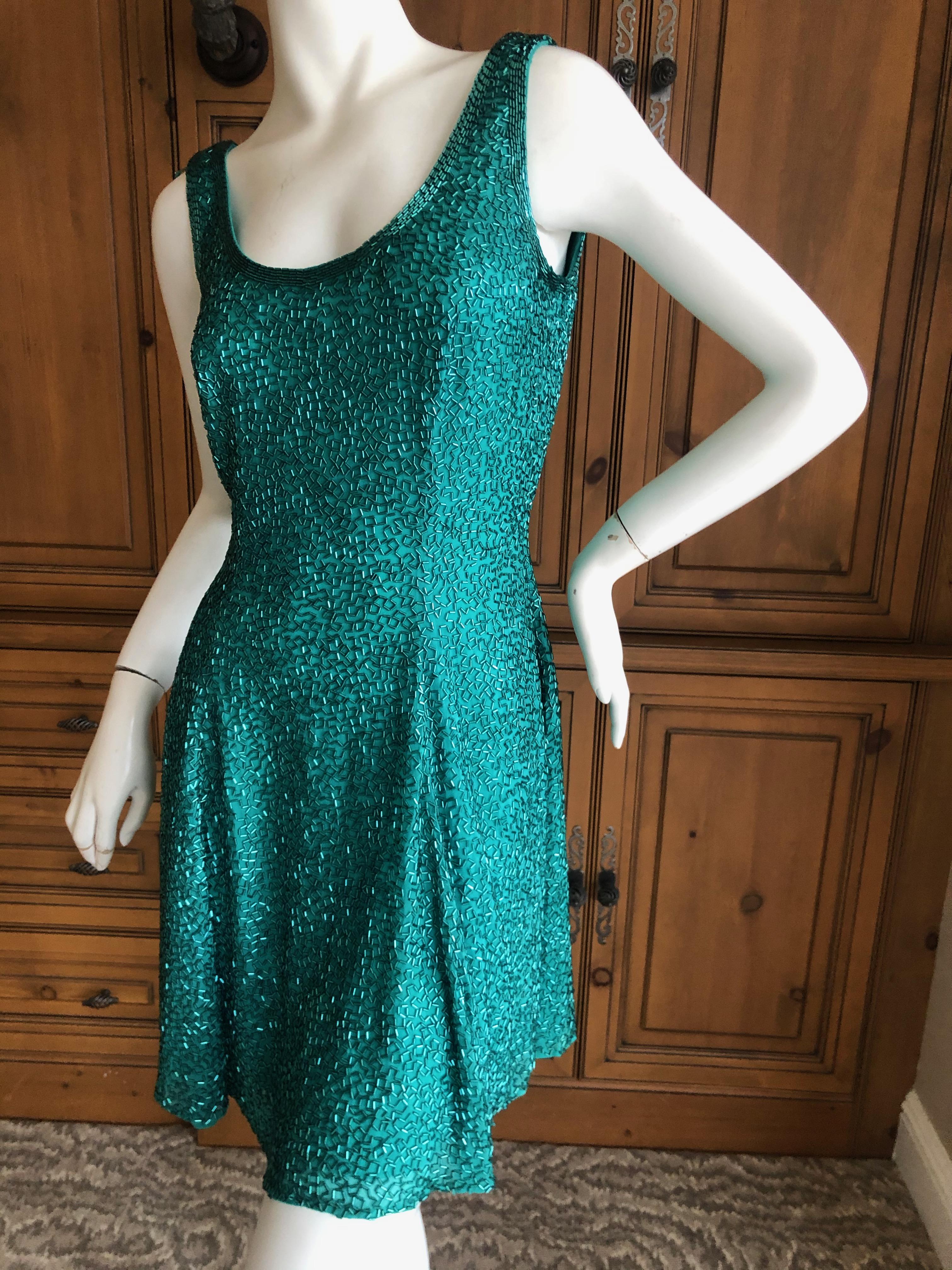 Oleg Cassini Seventies Sequin Beaded Backless Evening Dress.
DIsco era divine, so much prettier in person.
Made back in the seventies , this is all glass beading and is  comparable to a Bob Mackie from the same era.
Size 4, but runs large
Bust