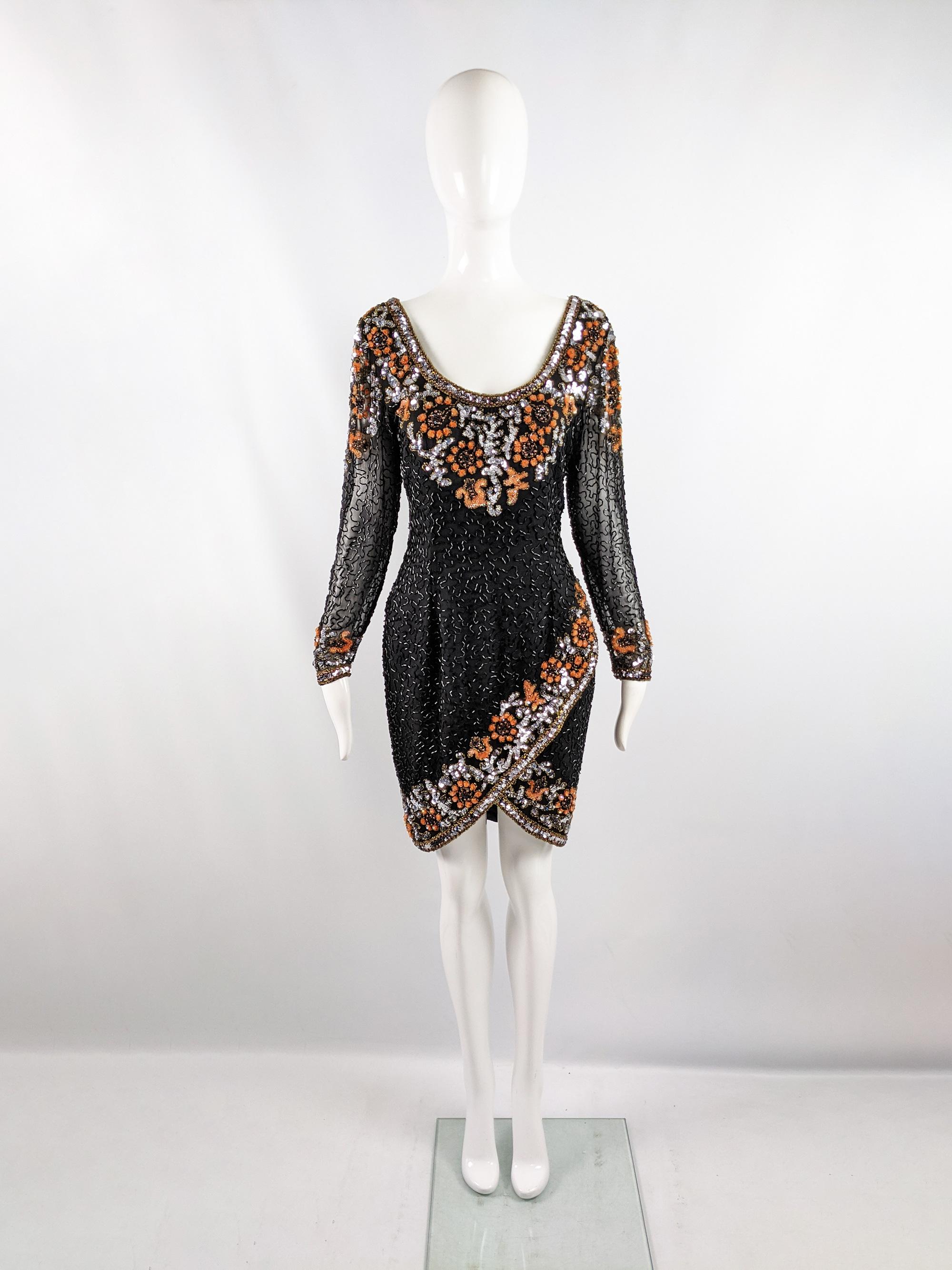 A fabulous vintage womens party dress from the 80s by luxury fashion designer, Oleg Cassini. In a black pure silk chiffon, heavily embellished with black glass bugle beads, orange and silver sequins and gold seed beads. It has long, sheer sleeves, a