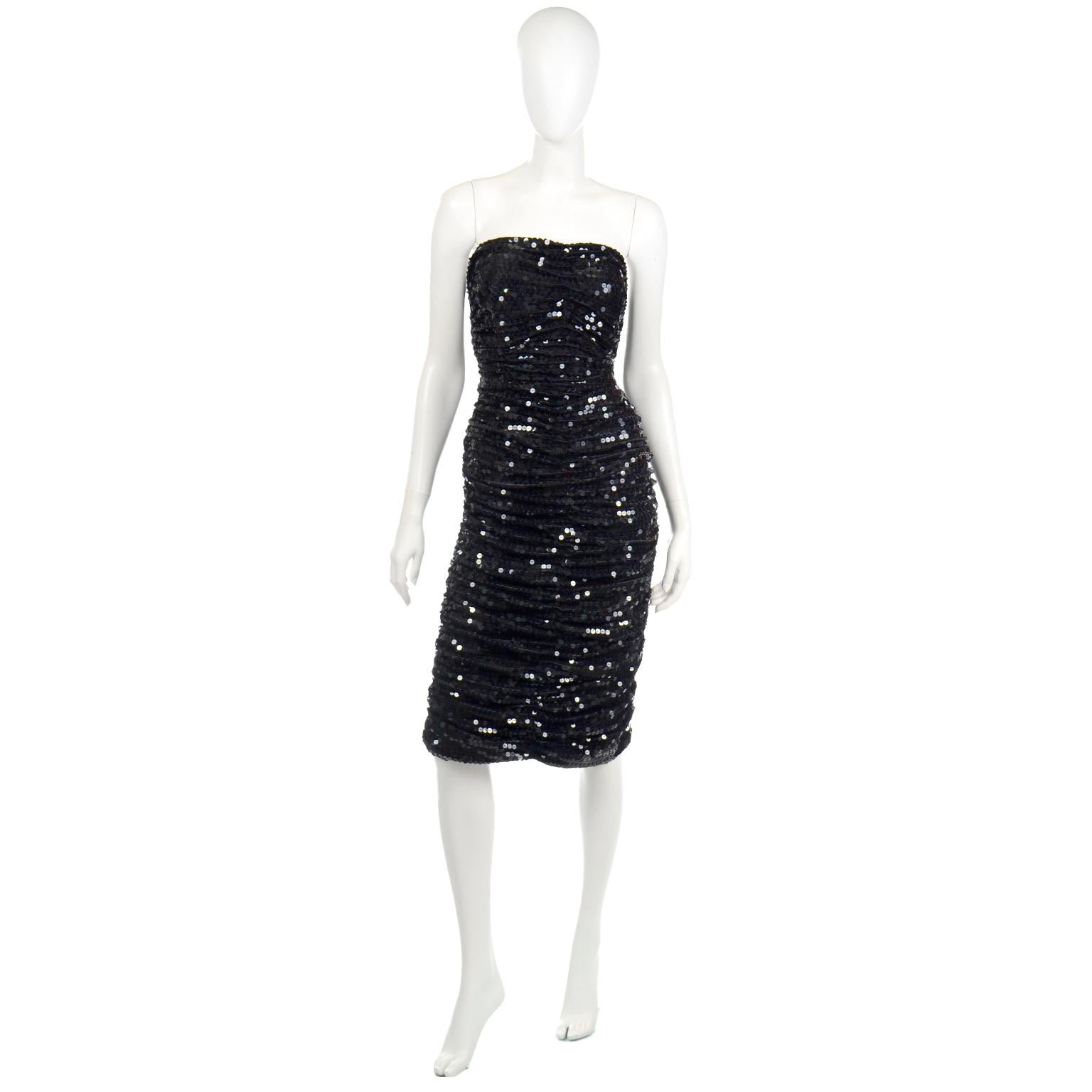 This is a shimmering vintage Oleg Cassini black sequin strapless evening dress with ruching throughout. This dress can take you all through the holidays and could be worn anytime during the year to a special evening event. There is 