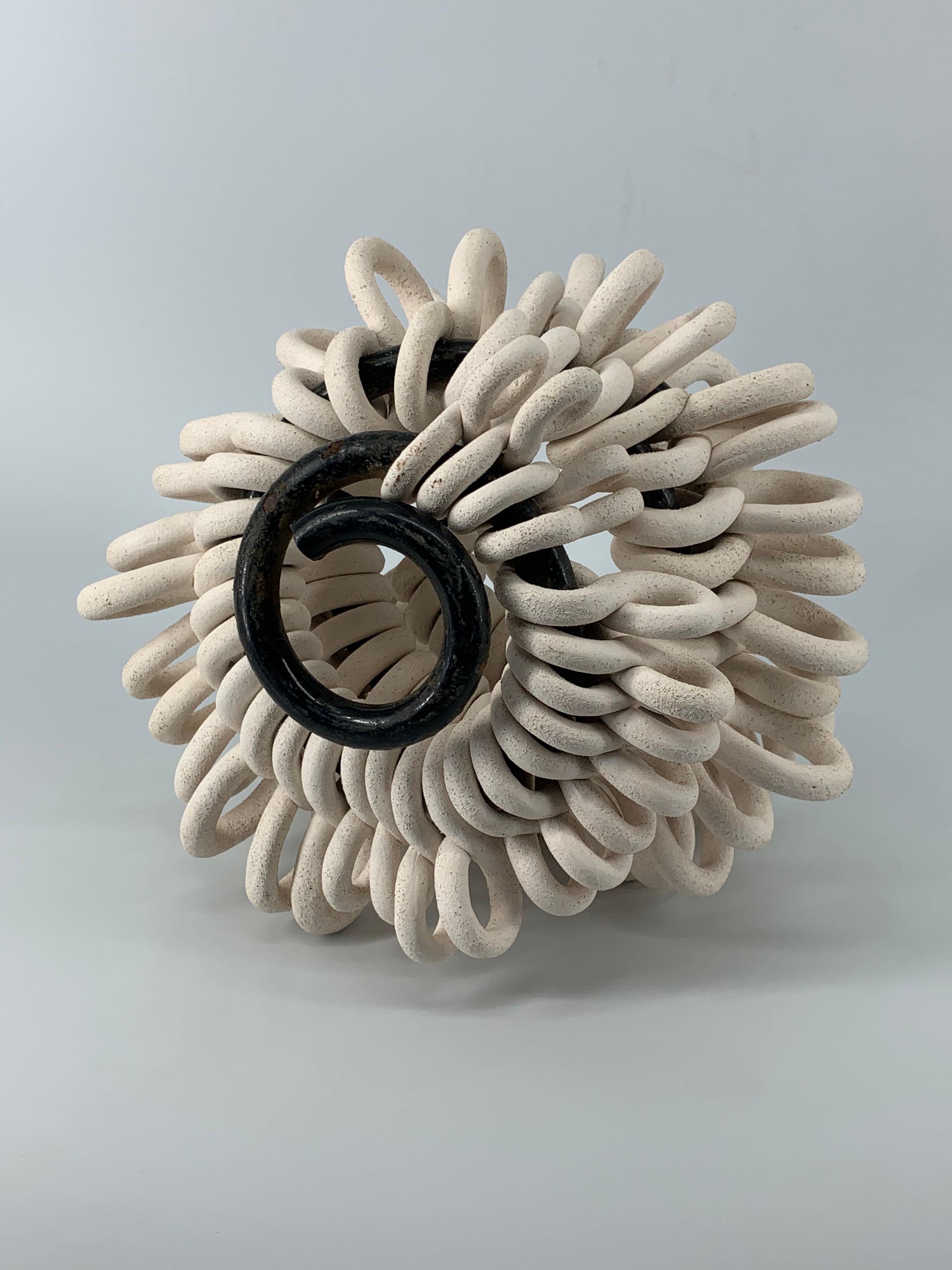 Materials: Chamotte, glazing, metal spring, manual molding

Transformer,The series presents a symbol of spiral and infinity, consisting of many ceramic symbols of infinity. It is a symbol of life and death. It is a constant movement of the universe