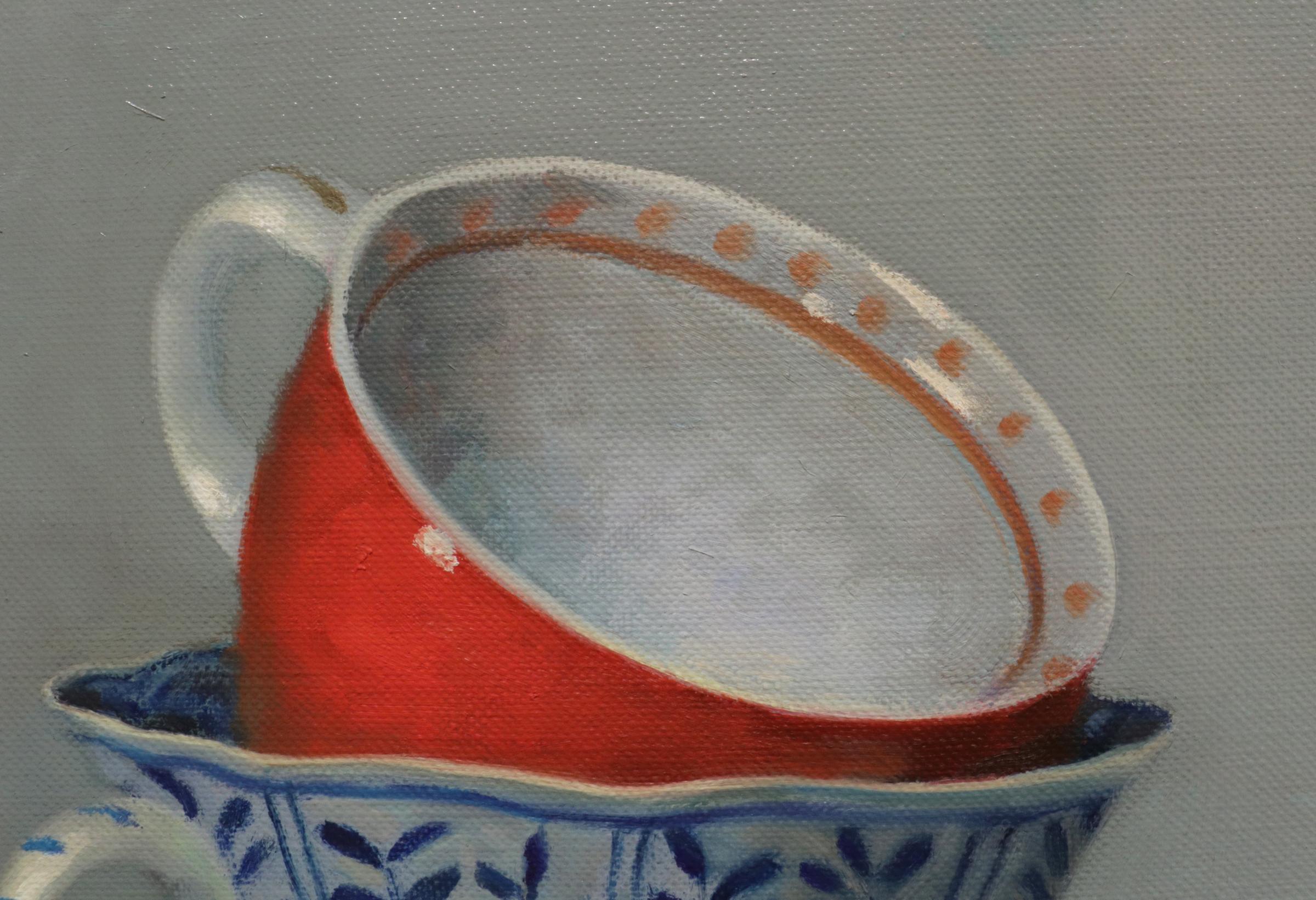 RED AND BLUE TEACUPS - contemporary still life of porcelain cups - Painting by Olga Antonova