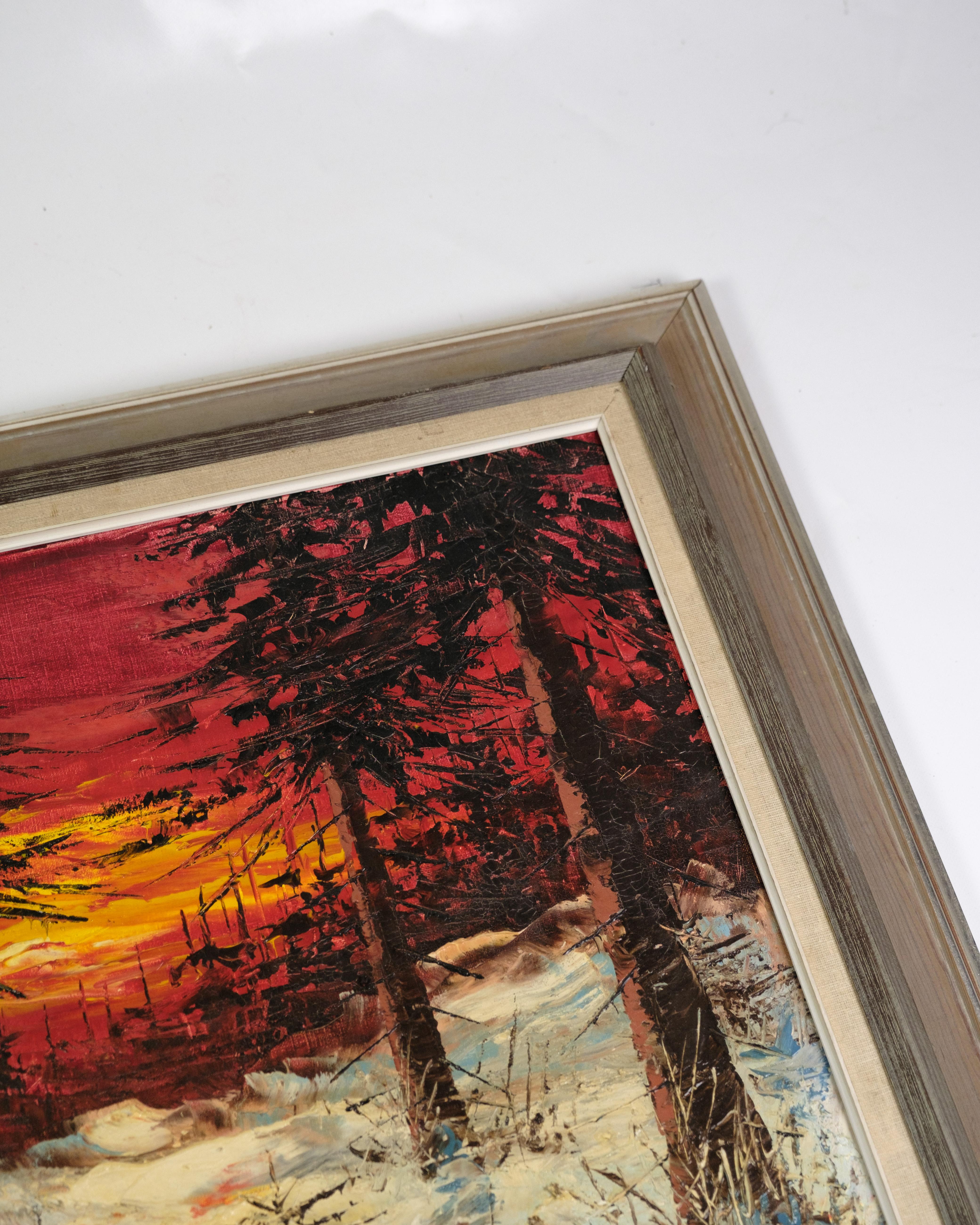 Oil painting with a motif of a snow-covered spruce forest and a sunset in the background, which creates an atmospheric light over the landscape. The painting is framed in a solid wooden frame, which emphasizes the natural beauty of the