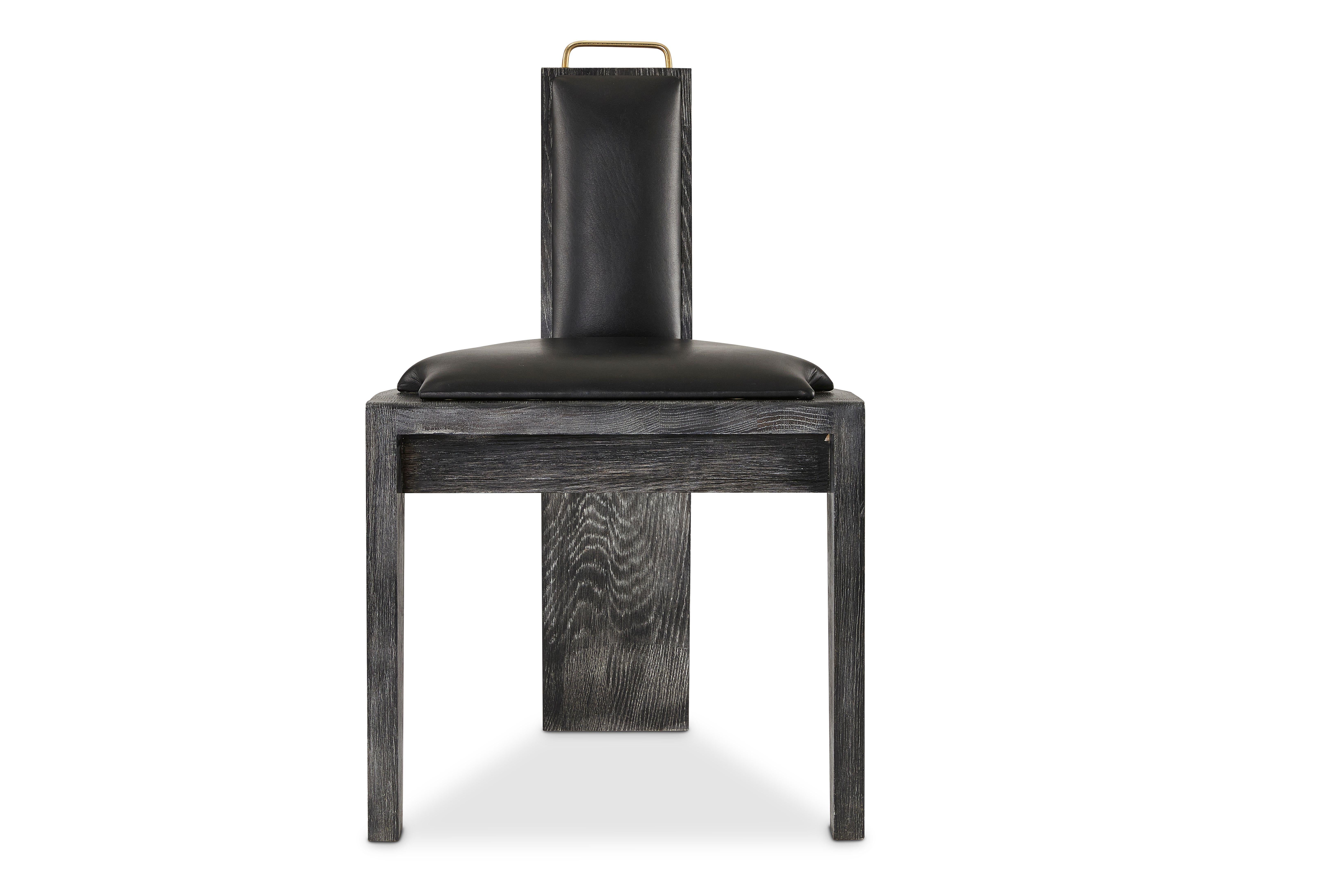 Olifant black dining chair by Egg Designs
Dimensions: 50 L x 53 D x 84 H
Materials: Ceramic, brass handle, black cerused oak, leather upholstery

Founded by South Africans and life partners, Greg and Roche Dry - Egg is a unique perspective in