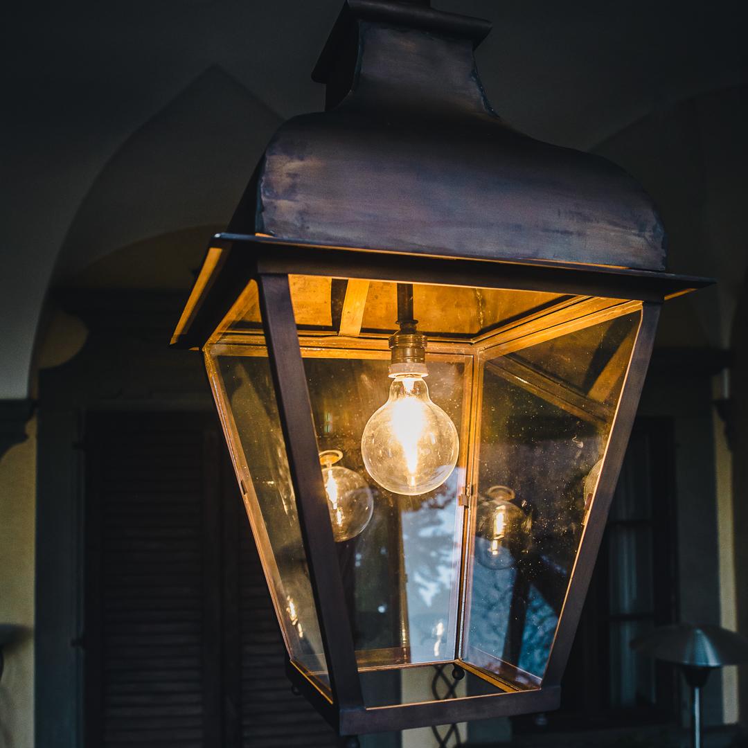 Description

Olimpia is the outdoor lantern in burnished brass with a square base, ideal for decorating entrances and facades.
Simple lines give way to the characteristic burnished shades of brass and  embellish the environment.
The lantern is