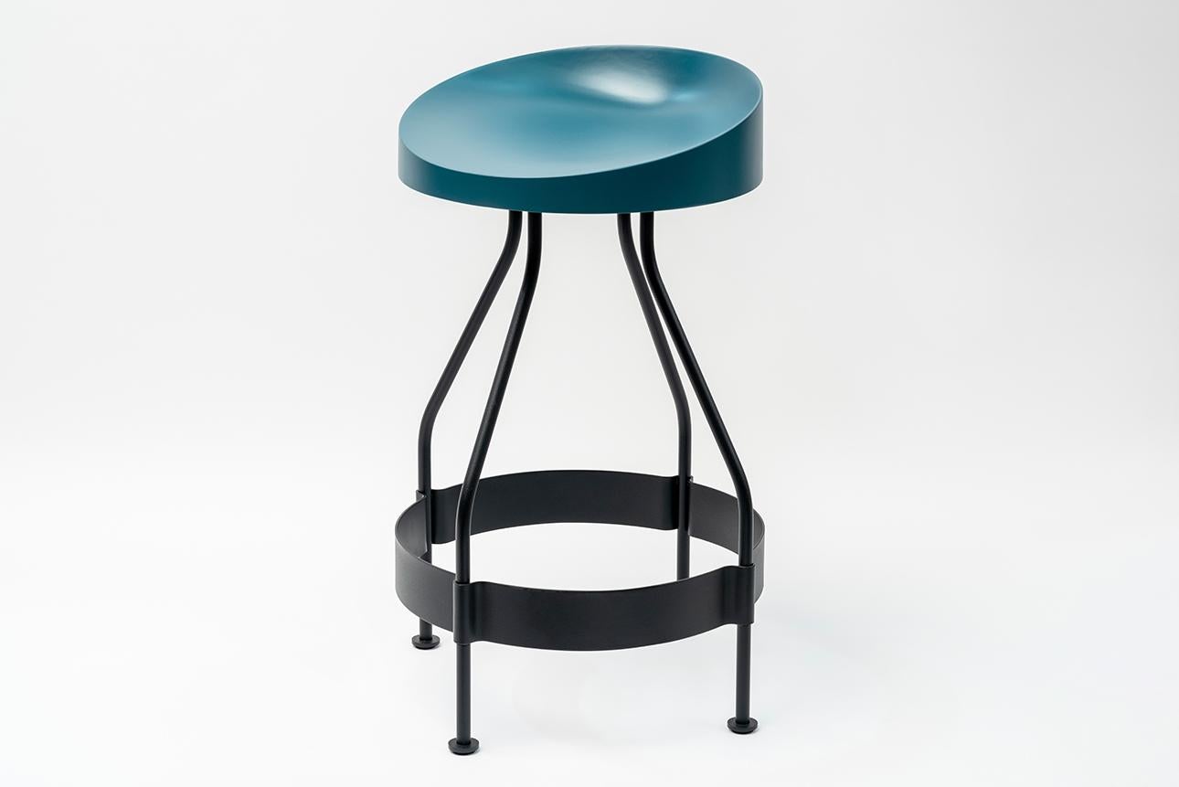 Olindias outdoor tabouret by Luca Nichetto.
Dimensions: W 48 x D 48 x H 73 cm
Materials: Black powder coat metal structure, seat in black/coral/duck blue/warm grey lacquered poliurethane

Olindias is a bar stool that can easily be adapted to all