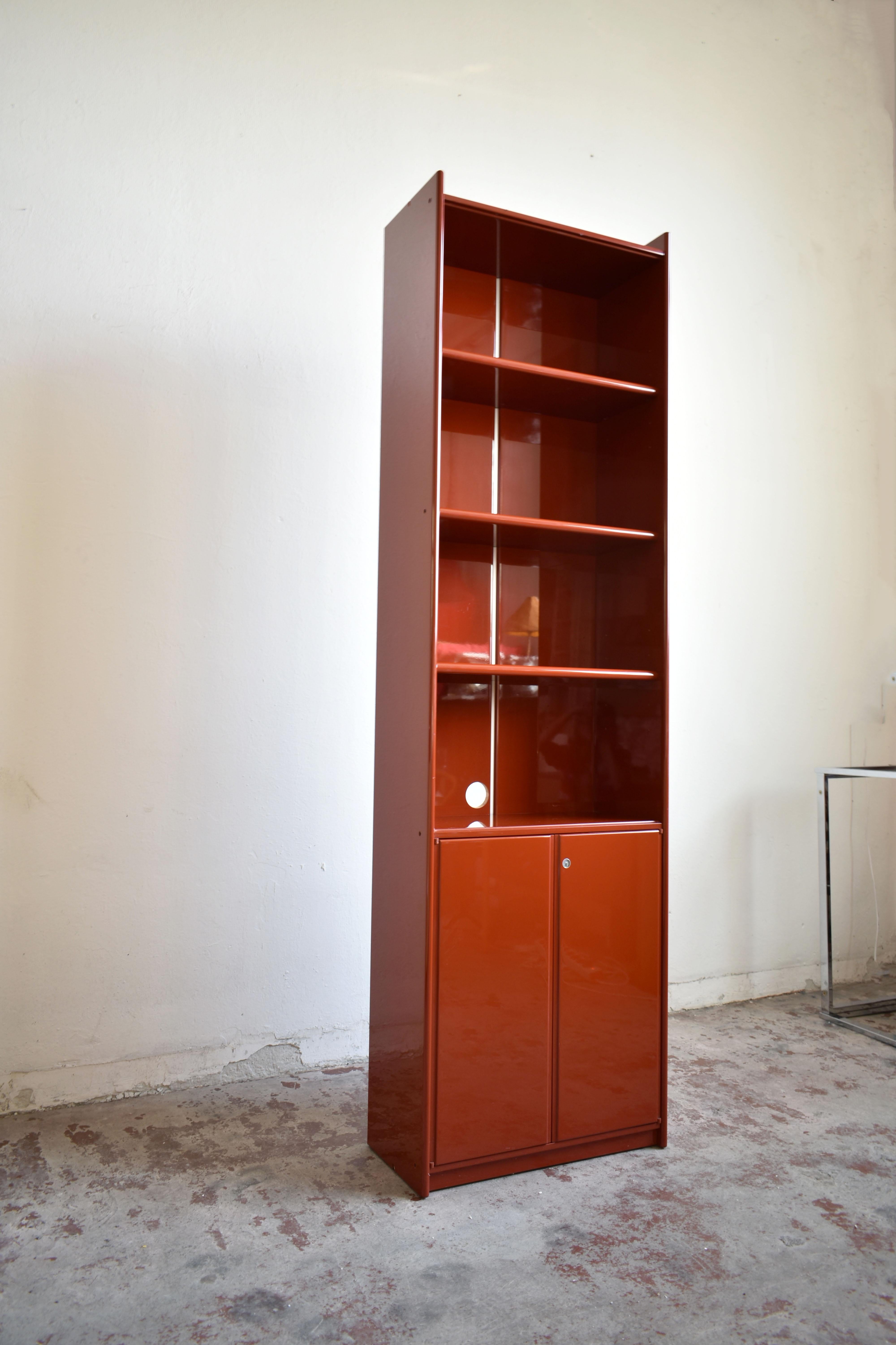 The 'Olinto' bookcase was designed by Kazuhide Takahama in 1965 for the world-famous Italian high-end furniture company B&B Italia

The one offered here for sale is composed of two separate units made of wood lacquered in beautiful brick red color