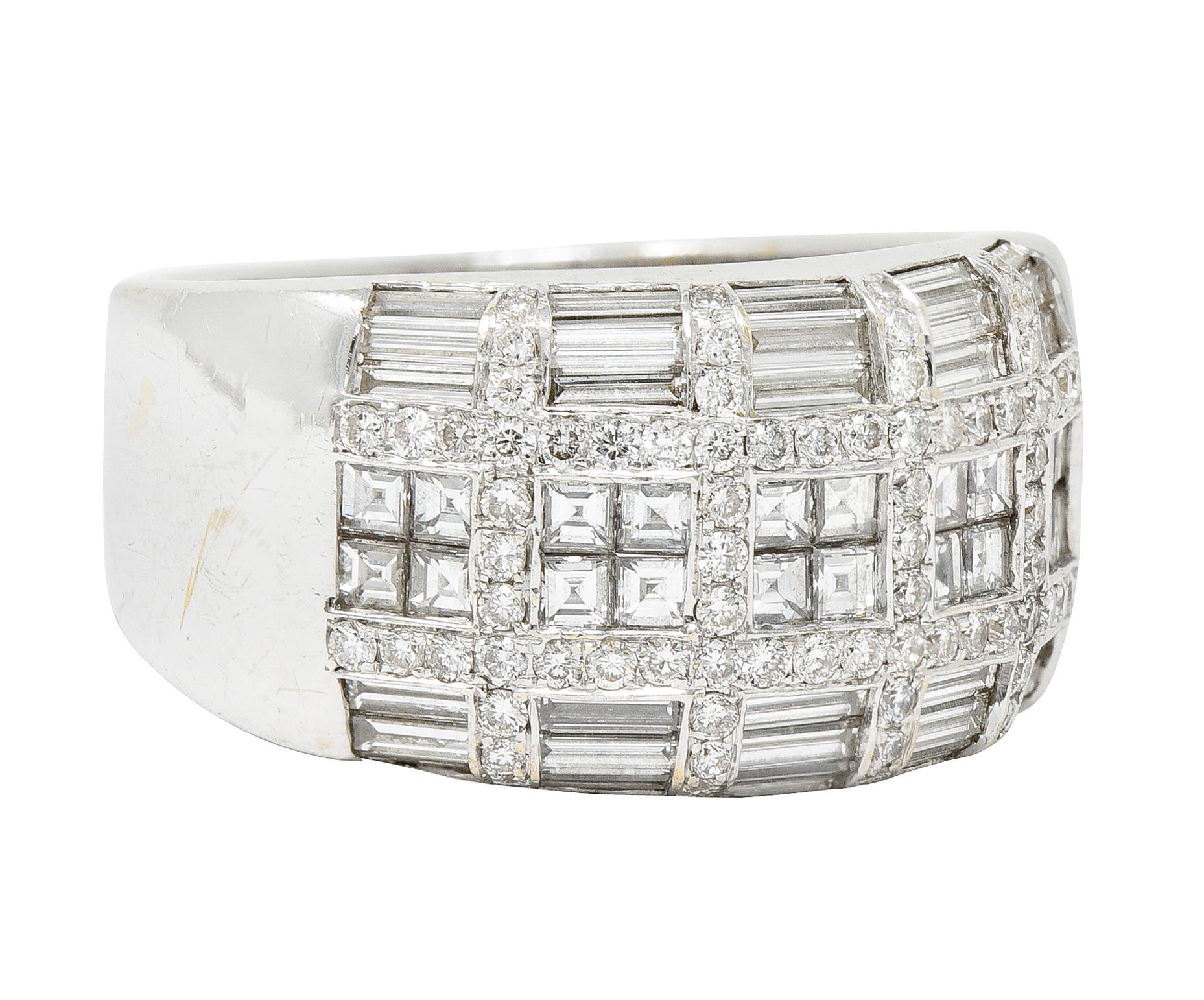 Wide band ring features a front facing grid-like motif comprised of diamonds

Baguette cut diamonds are channel set while square step diamonds are mystery set

With round brilliant cut diamond accents throughout

Total diamond weight is