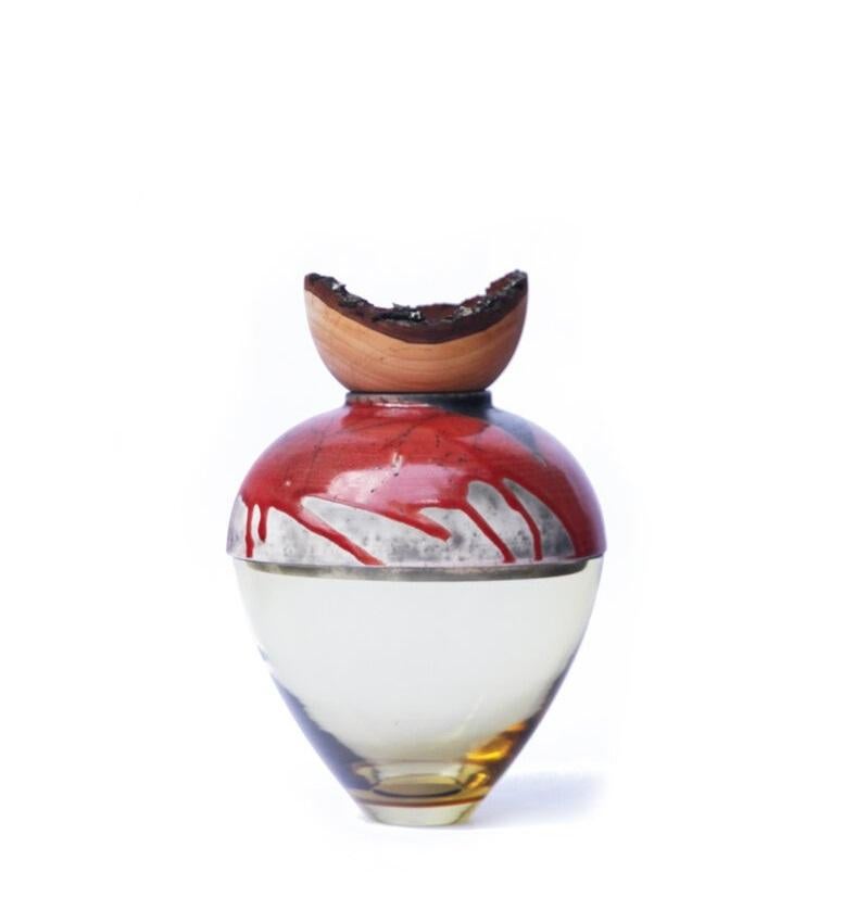 Olive and red butterfly stacking vessel, Pia Wüstenberg
Dimensions: D 20 x H 24
Materials: glass, wood, ceramic
Available in other colors.

A delicate piece with a mind of its own: beautiful patterns emerge from the glaze and the fire, making