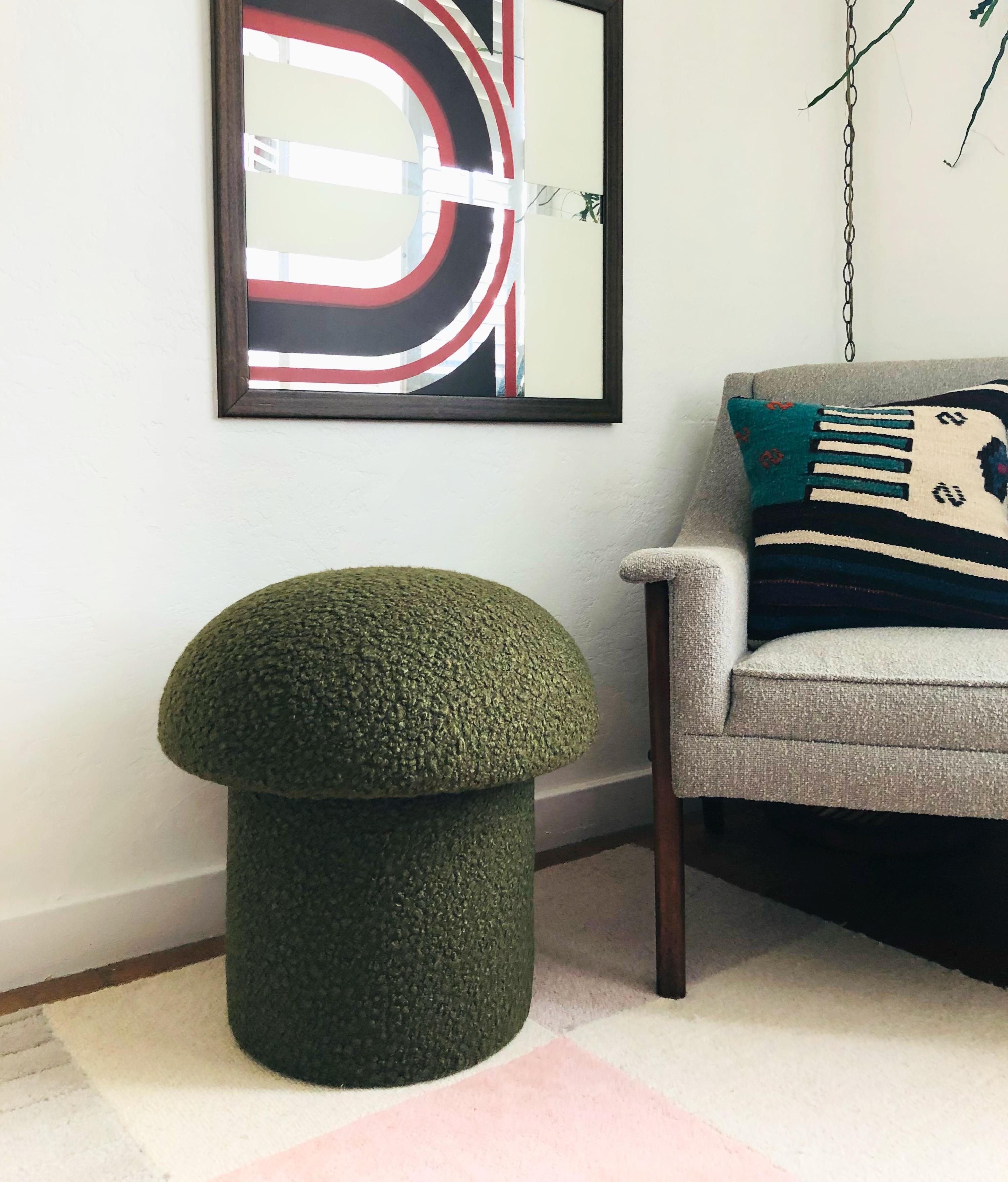 A handmade mushroom shaped ottoman, upholstered in an olive green colored curly boucle fabric. Perfect for using as a footstool or extra occasional seating. A great sculptural accent piece.

PLEASE NOTE:
Color variations may occur due to different