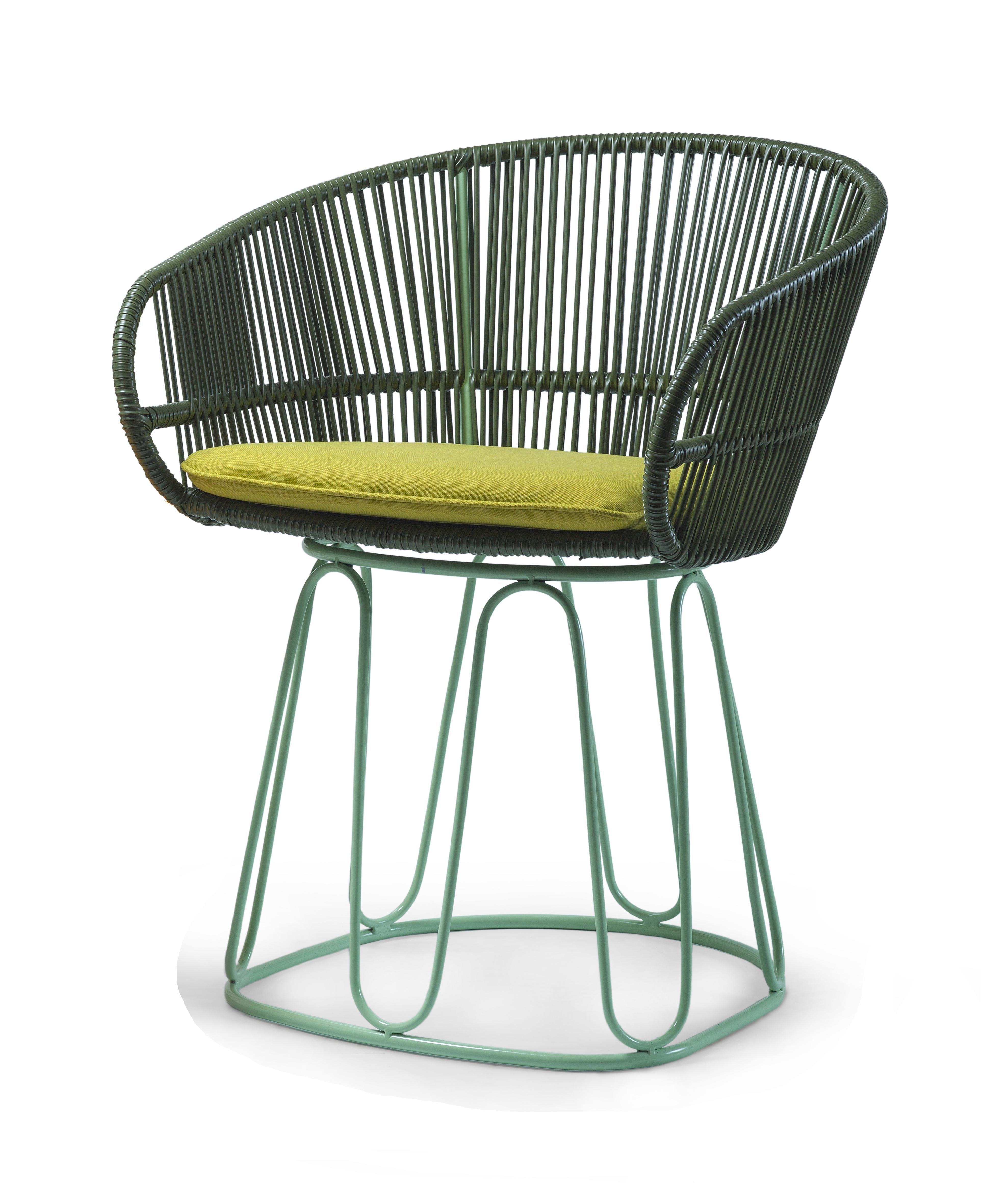 Olive Circo dining chair by Sebastian Herkner
Materials: galvanized and powder-coated tubular steel. PVC strings.
Technique: made from recycled plastic. Weaved by local craftspeople in Colombia. 
Dimensions: W 61.5 x D 56.5 x H 77.5 cm