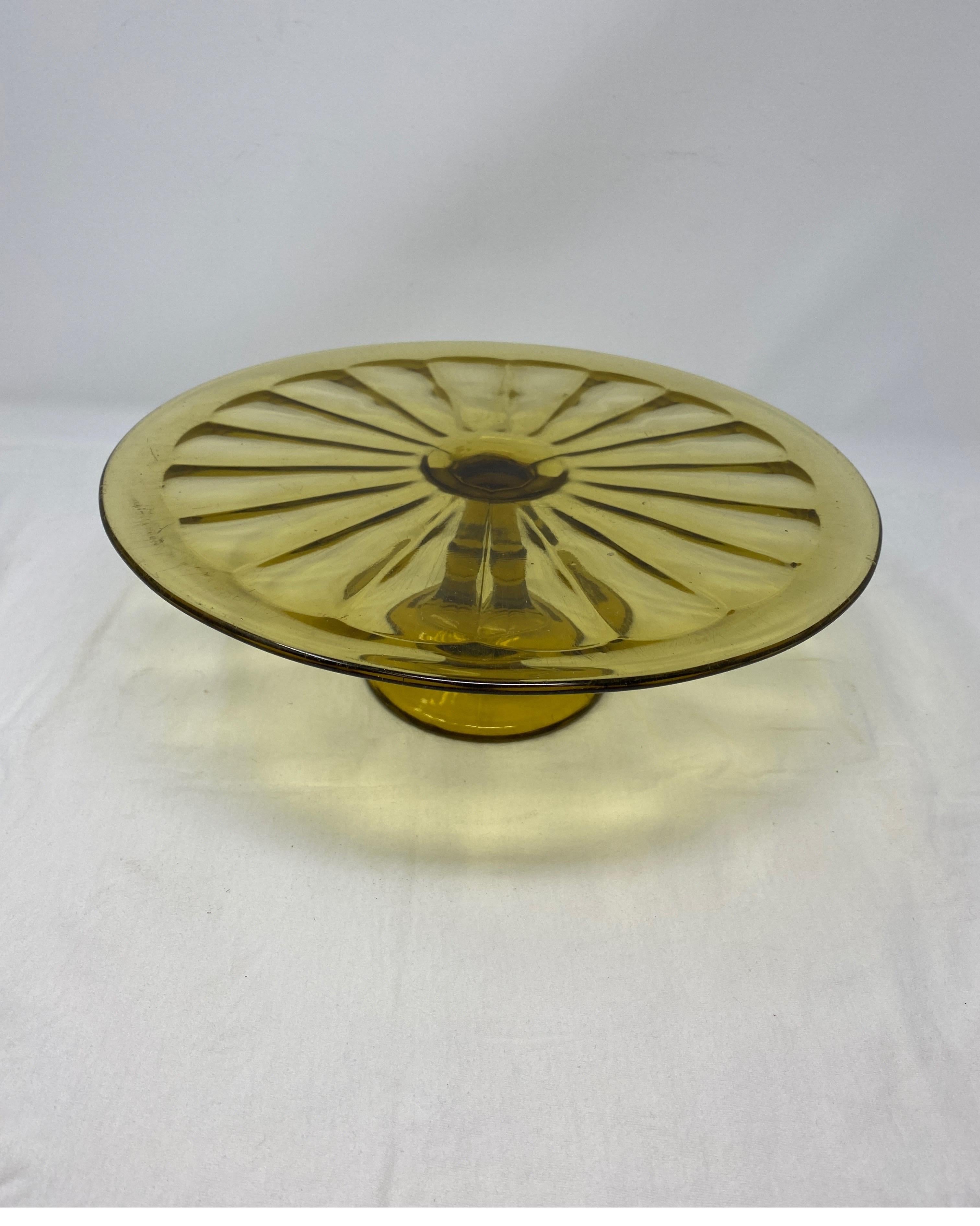 This antique glass cake patisserie stand sits on a glass pedestal base. Perfect for displaying your culinary confections, this piece’s simple, elegant look will mix with any decor.