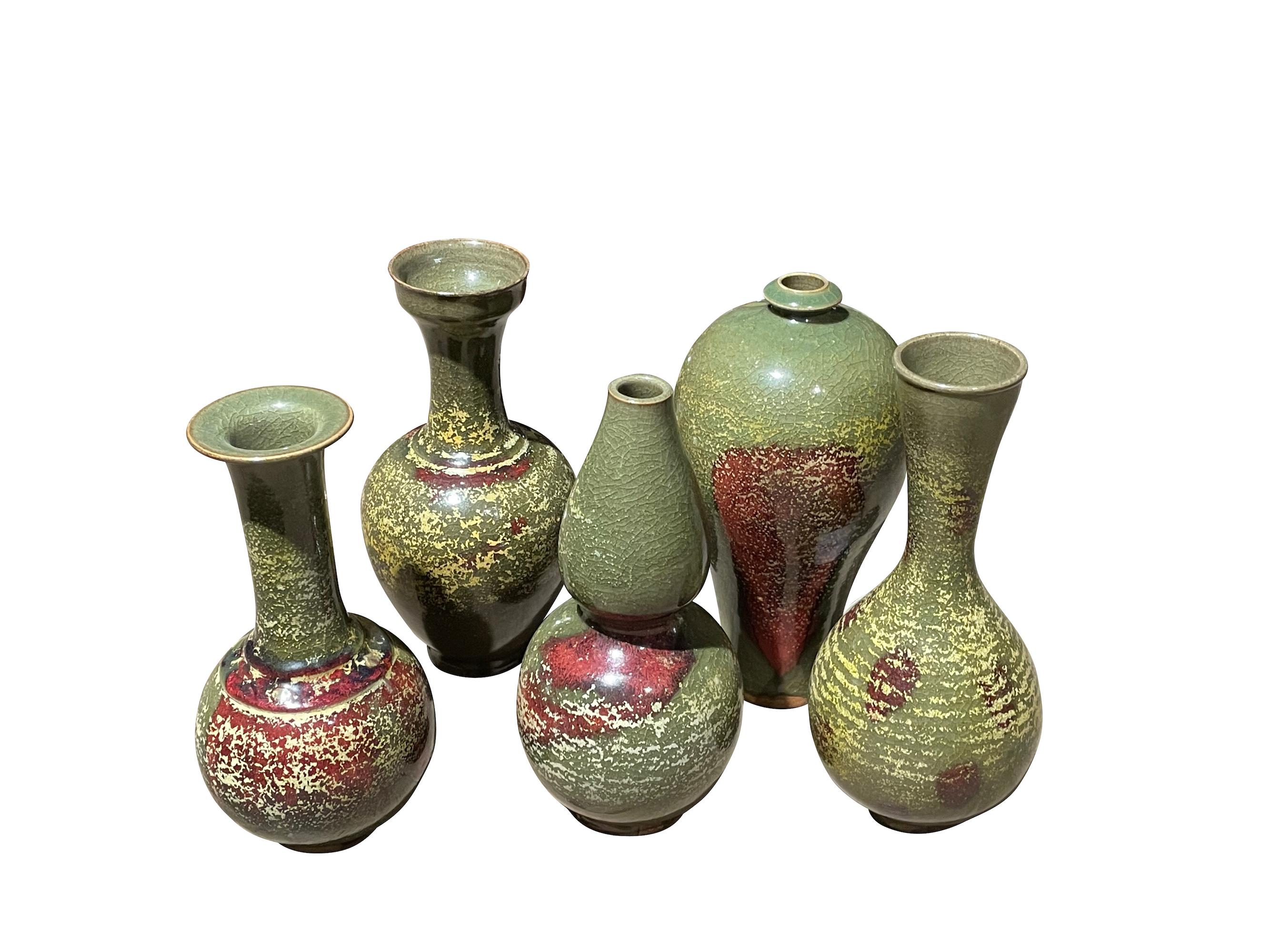 Contemporary Chinese gourd shape vase.
Olive glaze with burgundy accent.
From a collection of same colorways in different shapes and sizes.