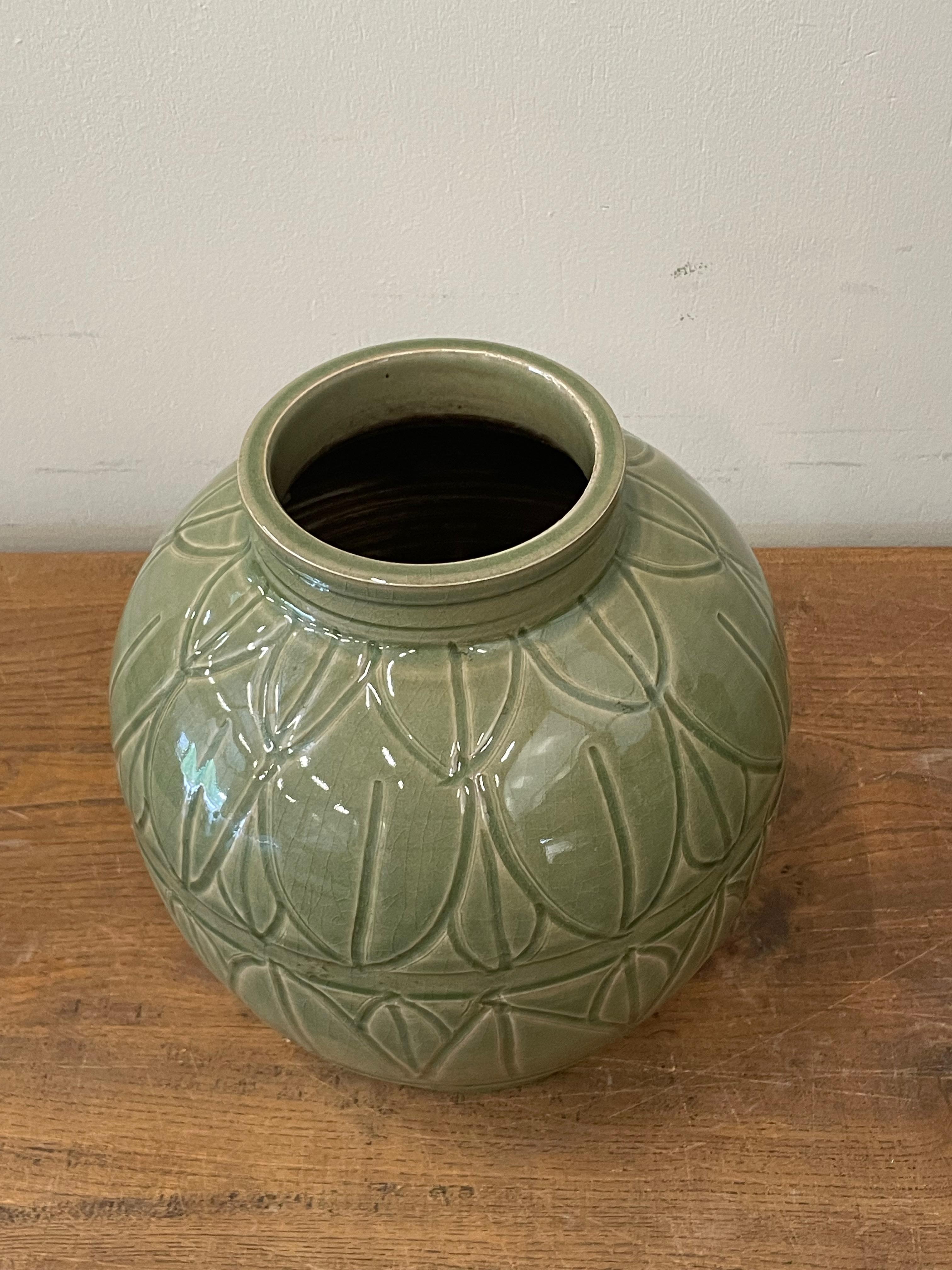 Contemporary Chinese glossy olive glazed vase.
Pot Shape.
Overall lotus leaf pattern.
Two available and sold individually.
Part of a large collection.