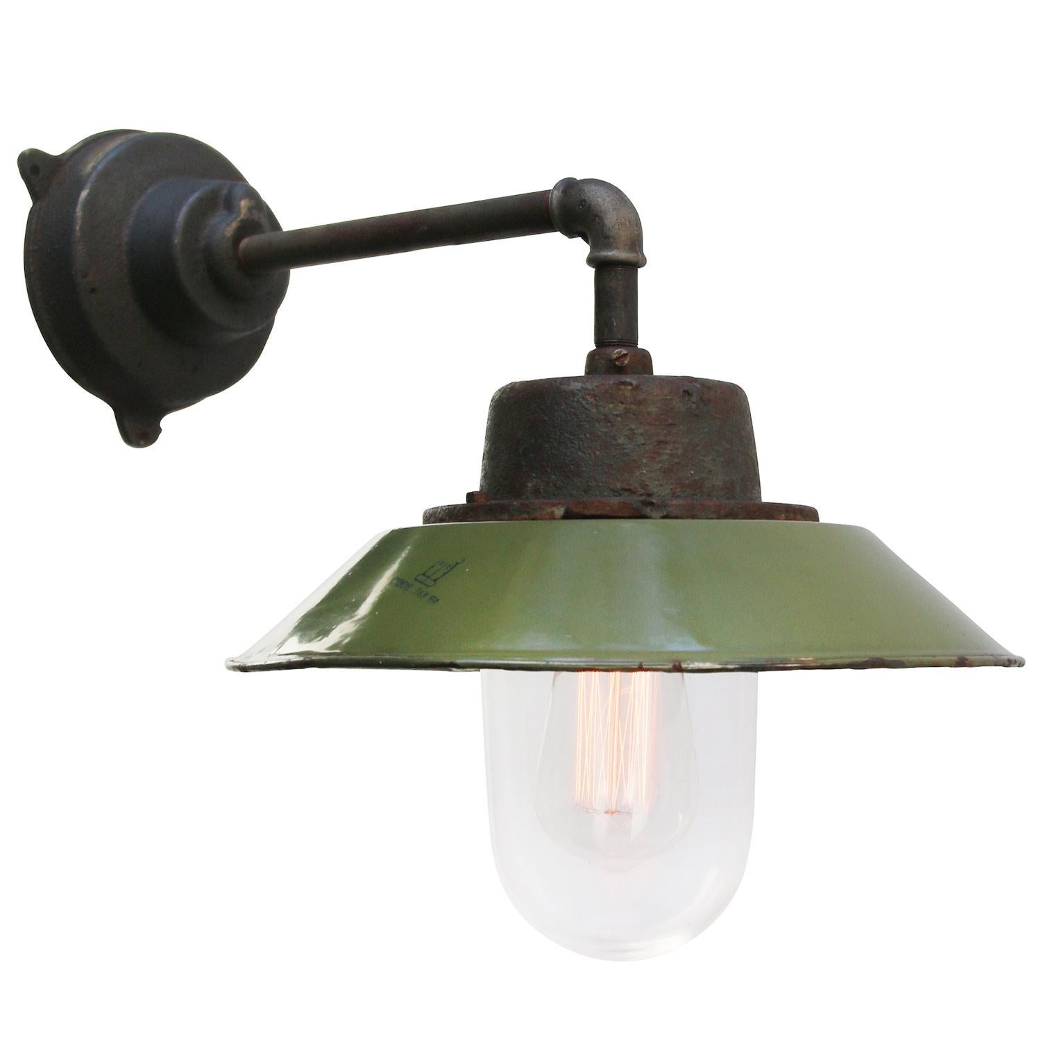 Green colored enamel industrial wall light with white interior.
Clear glass.

Diameter cast iron wall mount: 12 cm, 3 holes to secure.

Weight: 5.5 kg / 12.1 lb

For use outdoors as well as indoors. 

Priced per individual item. All lamps