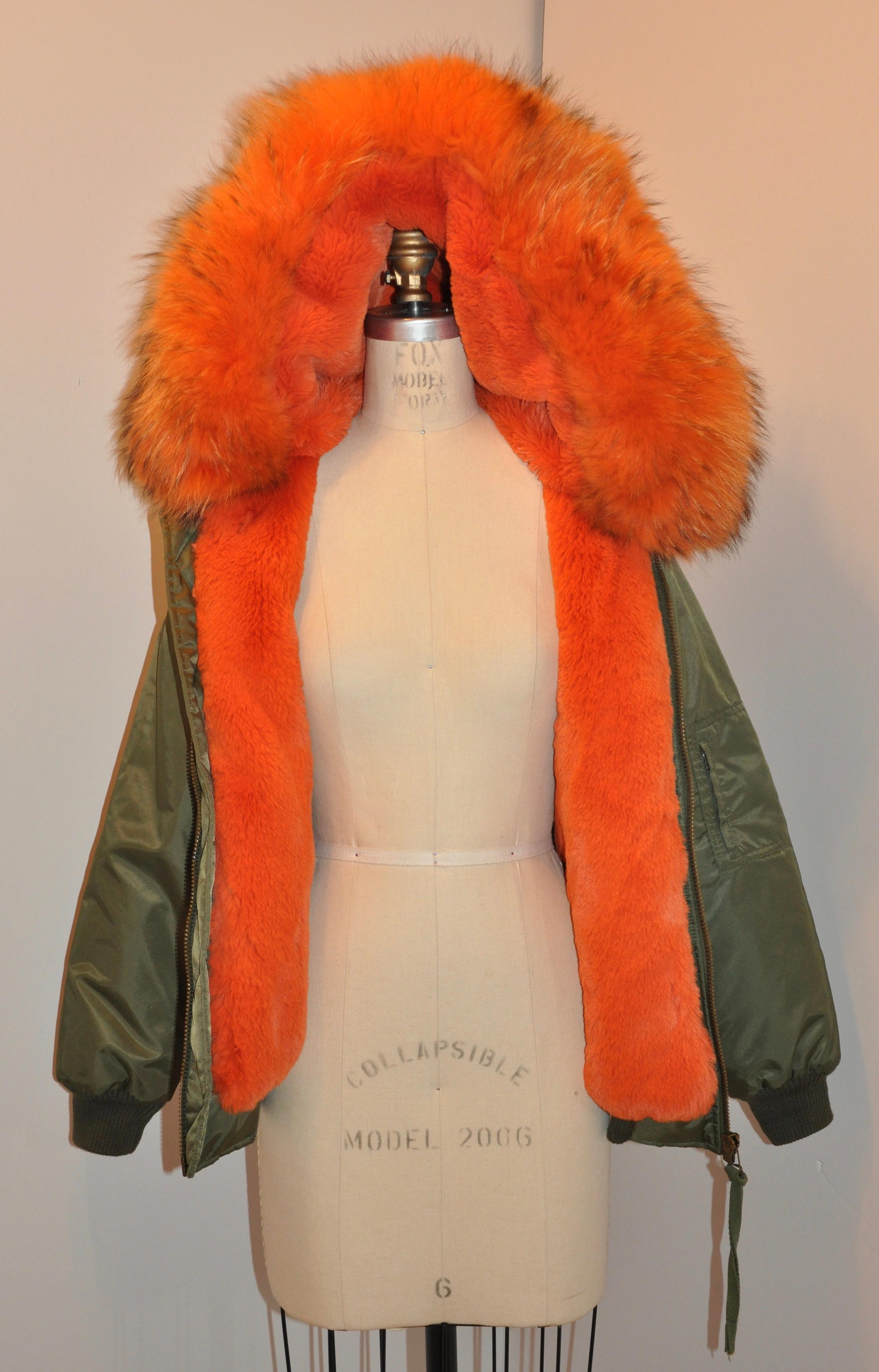 This wonderfully lightweight and cozy Olive-Green hooded zippered jacket is fully lined with bold sheared mink as well as bold fox in the hoodie. Shoulders measures 18 inches across, length is 25 1/2 inches, neck-to-shoulder is 5 1/4 inches, sleeve