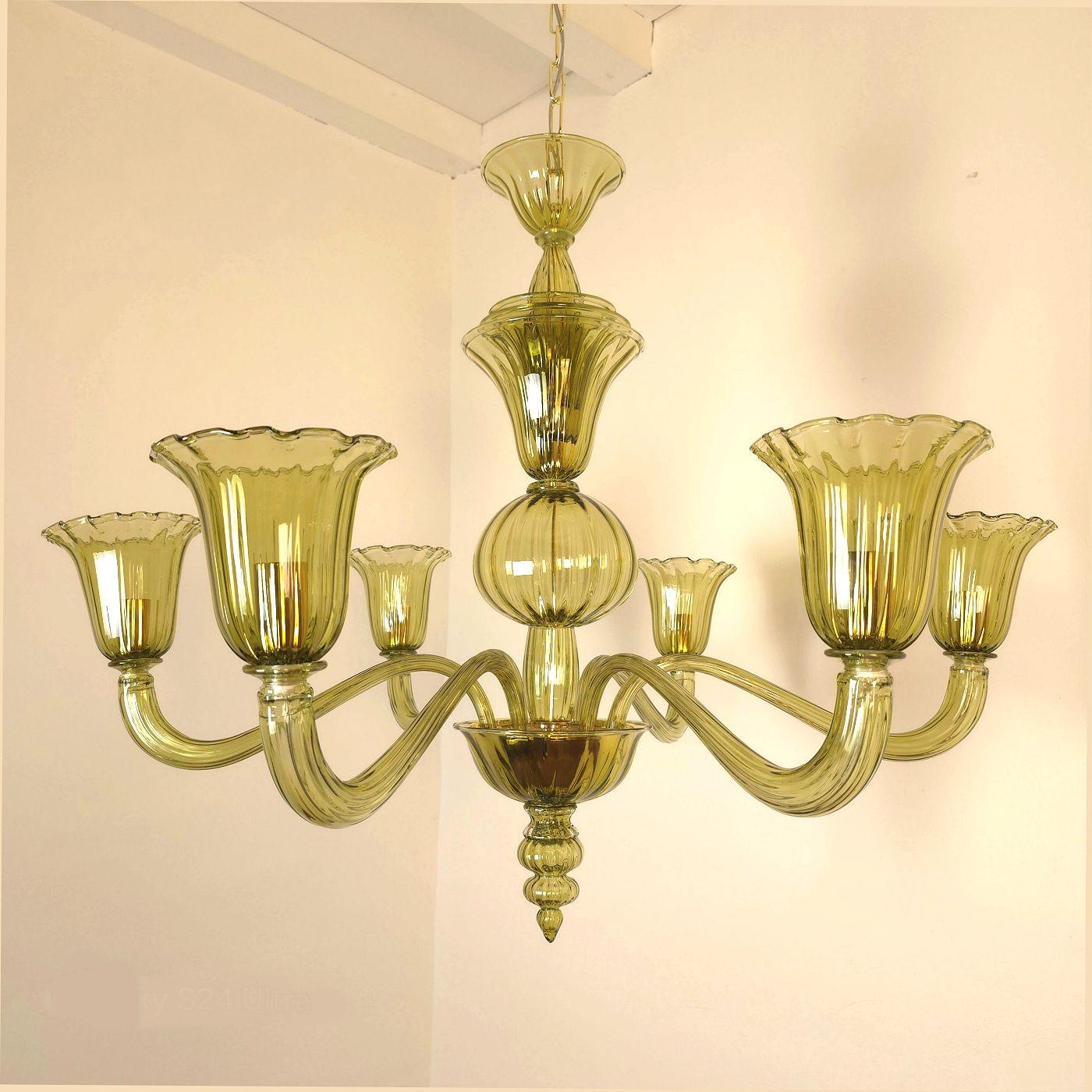 Olive green Murano glass chandelier, Venini style Italy circa 1980s.
Two chandeliers - a pair available.
Sold and priced individually.
The mid-century chandeliers design has a pineapple inspiration.
The Italian chandelier has 6 lights, arms.
It has