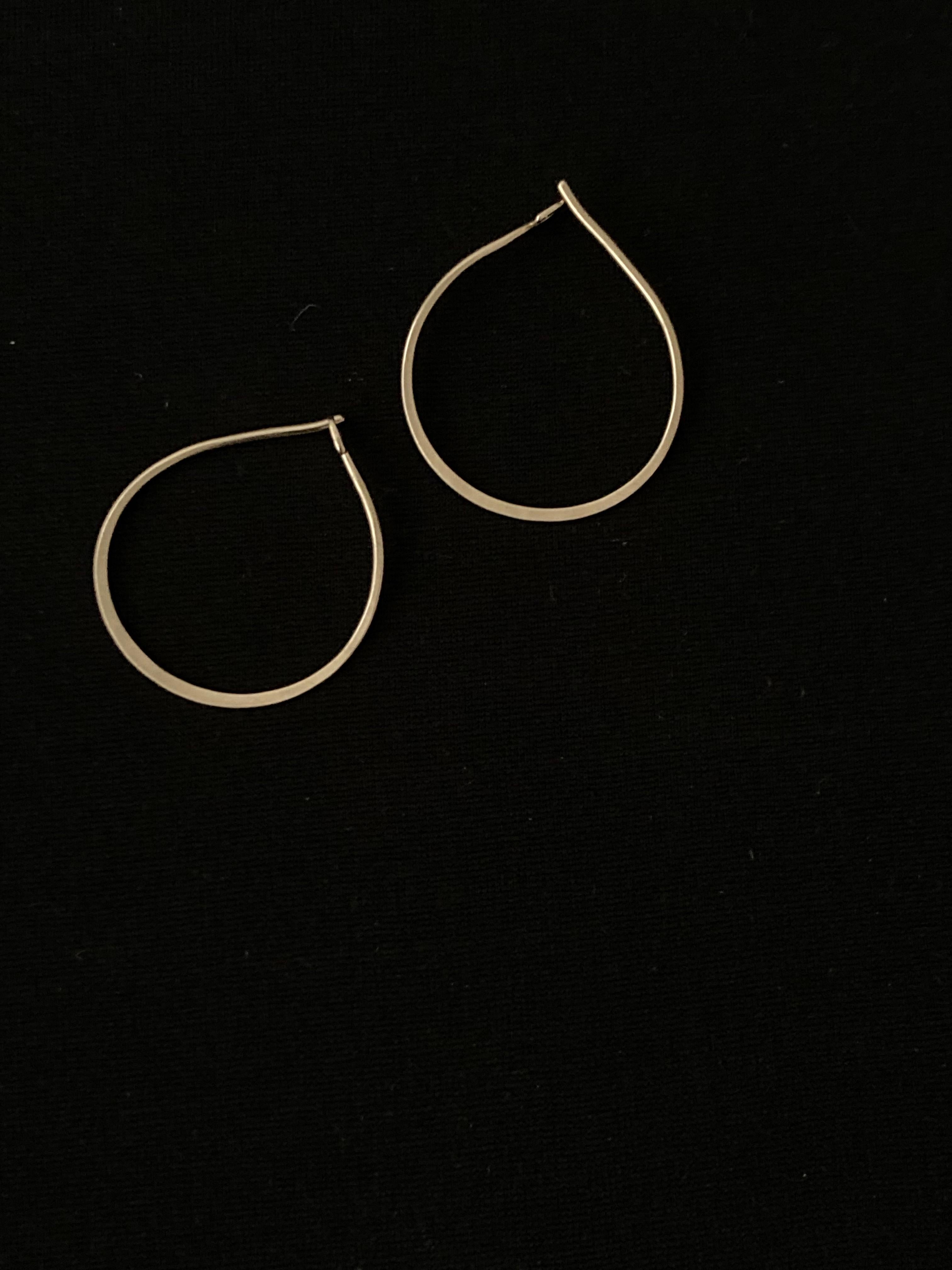 Solid 9ct Gold clicker hoops- these simple but luxury earrings are forged from a single piece of wire, and are tensioned so that they snap closed with a satisfying ‘click’.

Because the gold is hardened they are very securely fastened when worn,