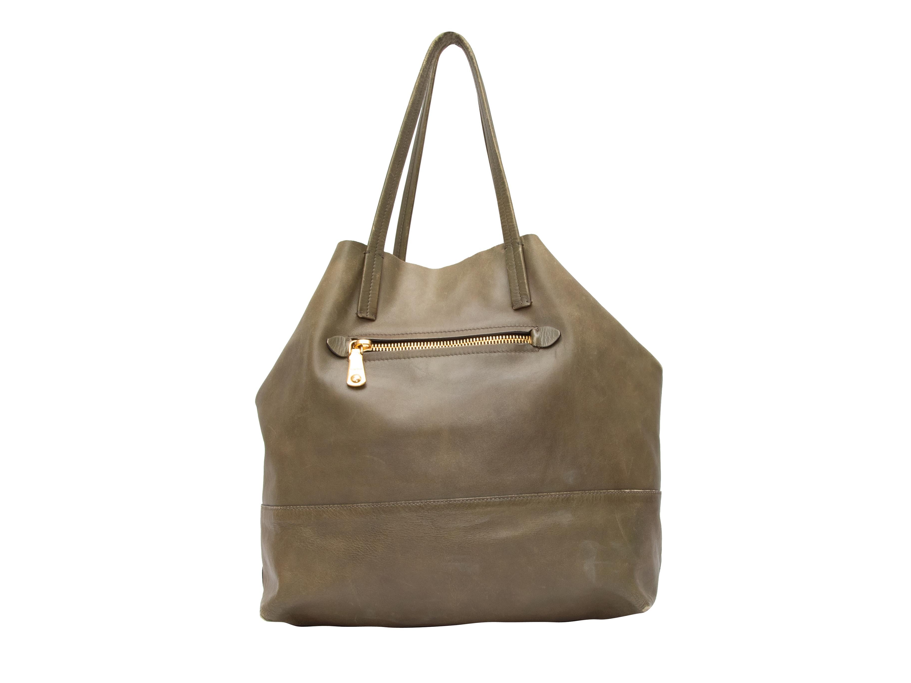 Olive Miu Miu Leather Tote Bag. This tote bag features a leather body, gold-tone hardware, a single front zip closure pocket, and dual flat top handles. 17