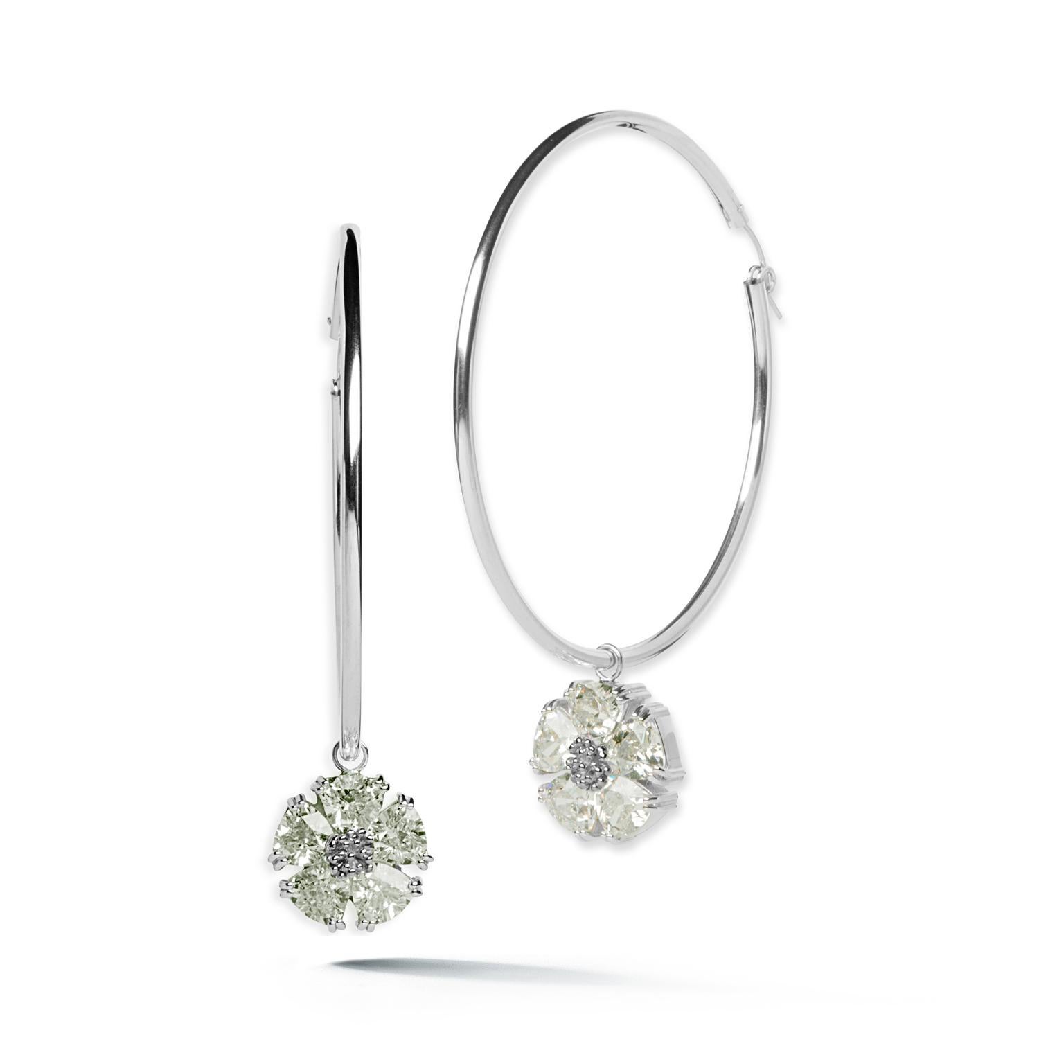 Designed in NYC

.925 Sterling Silver 10 x 7 mm Olive Peridot Blossom Stone Dangle Hoops. Big dangle hoops take on an edgy elegance with beautiful blossom with stones dangling. Blossom stone dangle hoops: 

	Sterling silver 
	High-polish