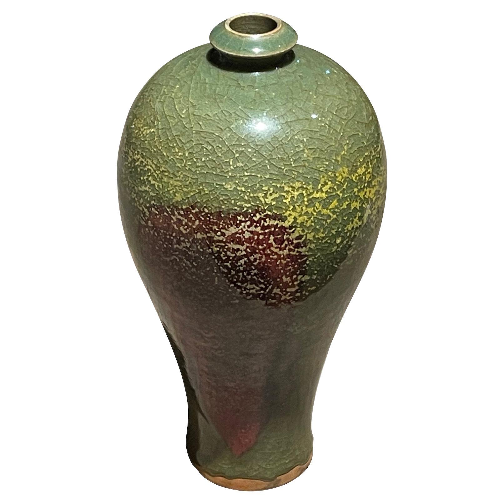 Contemporary Chinese thin small spout vase.
Olive glaze with burgundy accent.
From a collection of same colorways in different shapes and sizes.
Each vase sold individually.