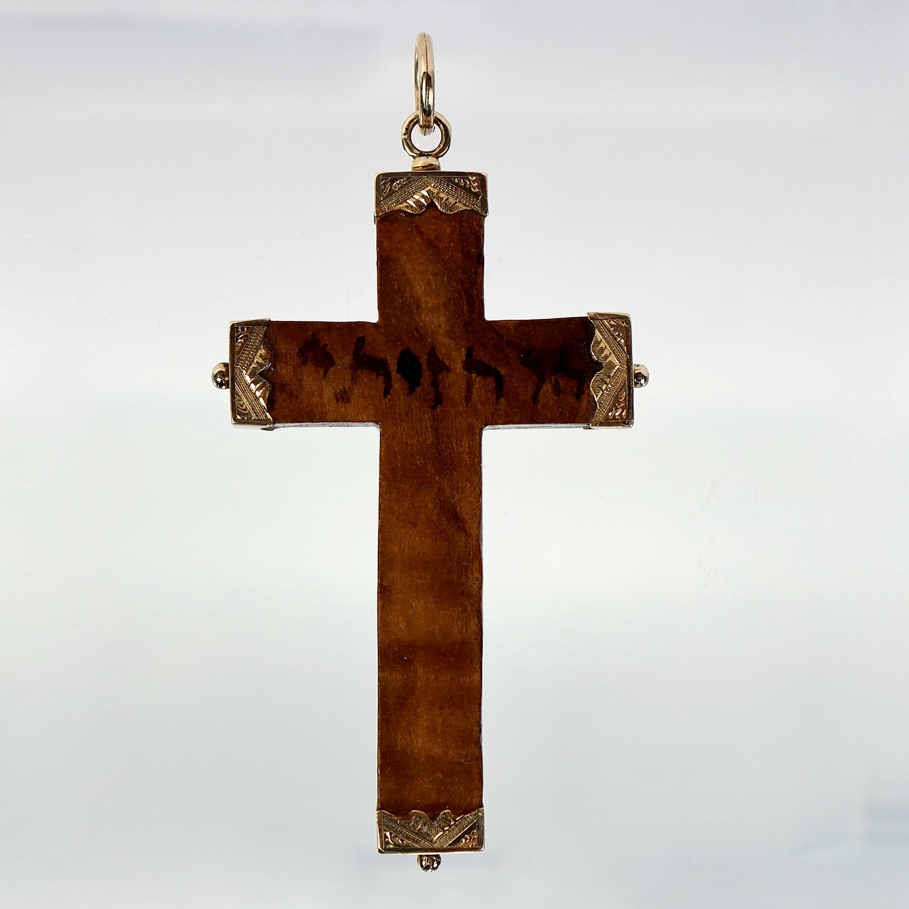 A very fine cross pendant.

A solid olive wood cross with decorative engraved 14k gold caps on ends.

Hebrew/Aramaic writing on center of cross.

Simply a wonderful  pendant cross!

Date:
20th Century

Overall Condition:
It is in overall good,