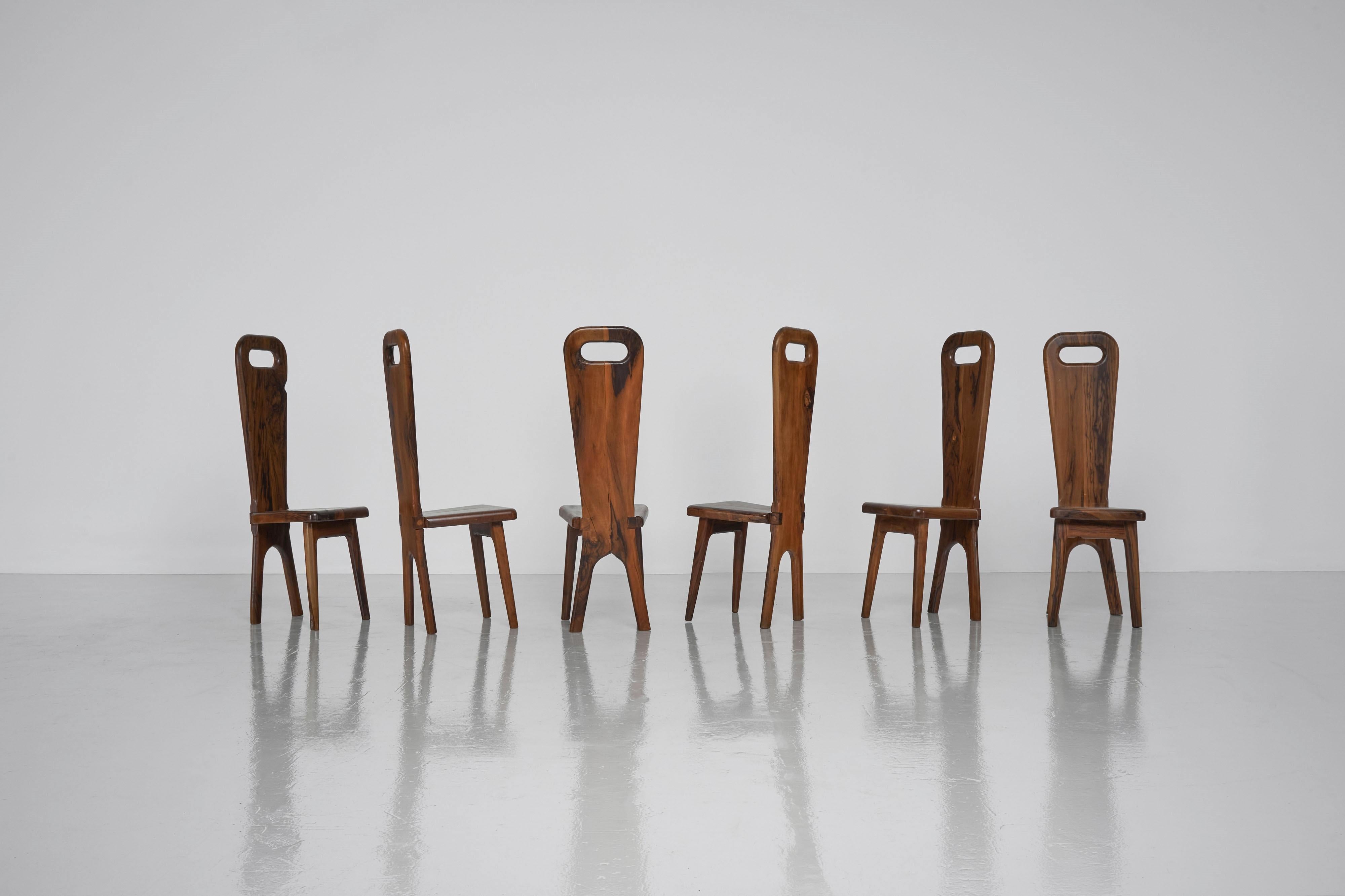 A unique set of 6 high back chairs made by an unknown artist from the south of France made in the 1960s. These chairs fit all the requirements for their brutalist interpretation of the artist. Rough wooden materials, elegantly crafted into an