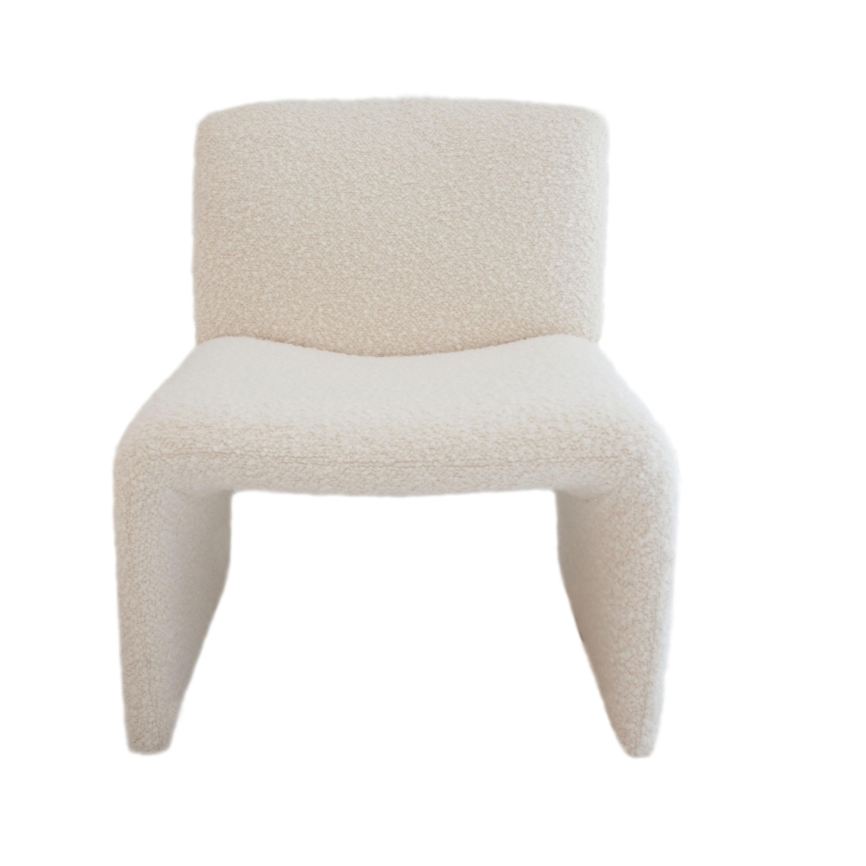 Mid-Century Modern armchair designed in the style of Oliver Mourgue. Solid wood structure upholstered in beige wool boucle.
