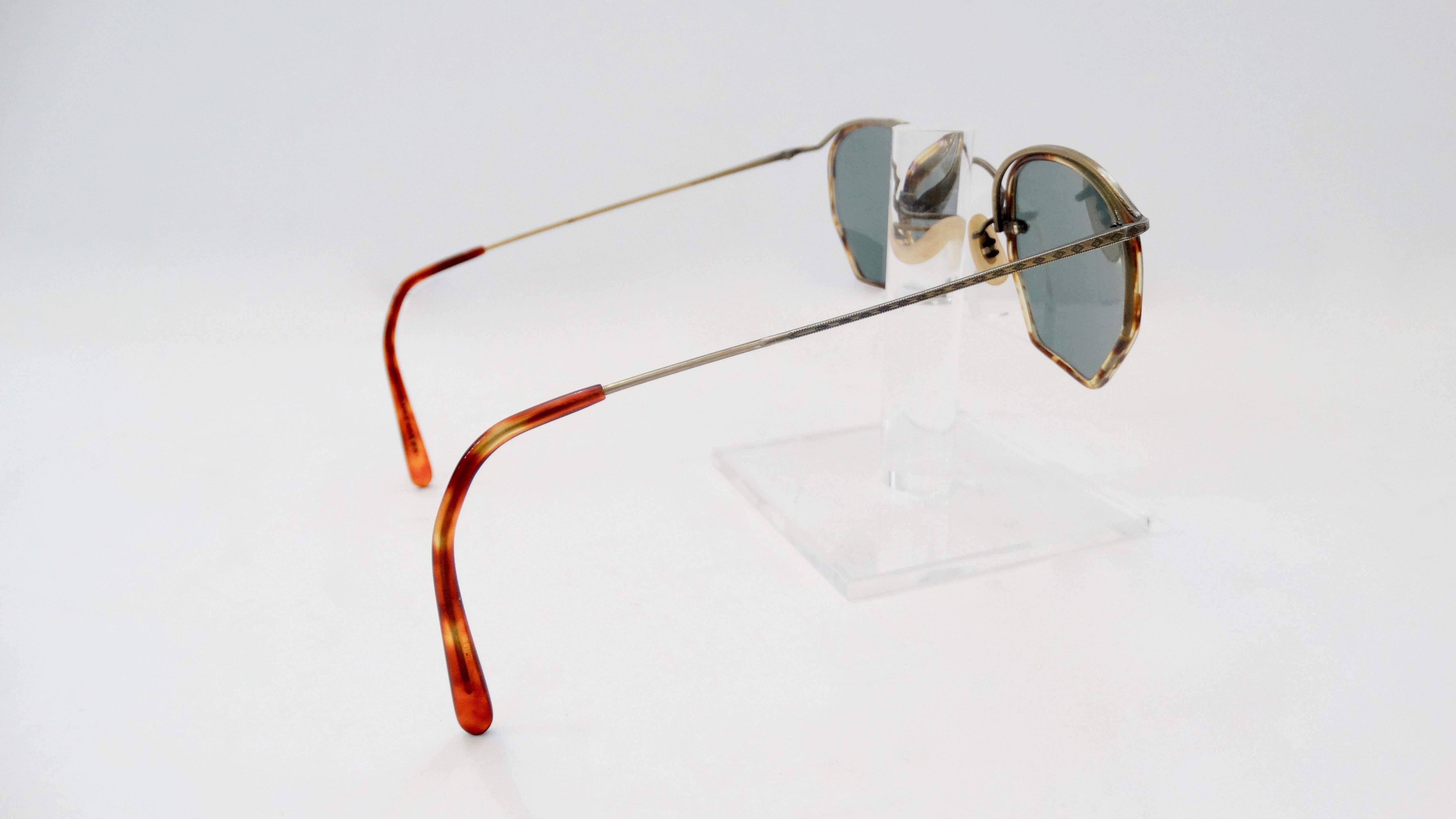 Make a statement with these Oliver Peoples sunglasses! Circa late 1980s, these sunglasses feature a rounded hexagon frame with a tortoise shell finish. Includes silver hardware embossed with a decorative design. The perfect pair of funky sunglasses