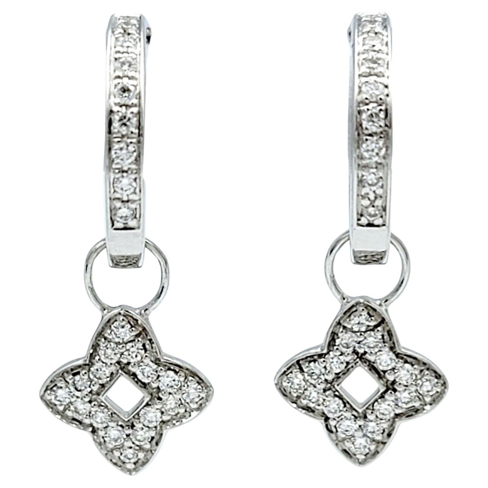 This gorgeous pair of Oliver Smith Signature Collection quatrefoil diamond charm hoop earrings exemplify elegance and sophistication in every detail. Crafted from lustrous 18 karat white gold, these earrings feature a timeless hoop design adorned