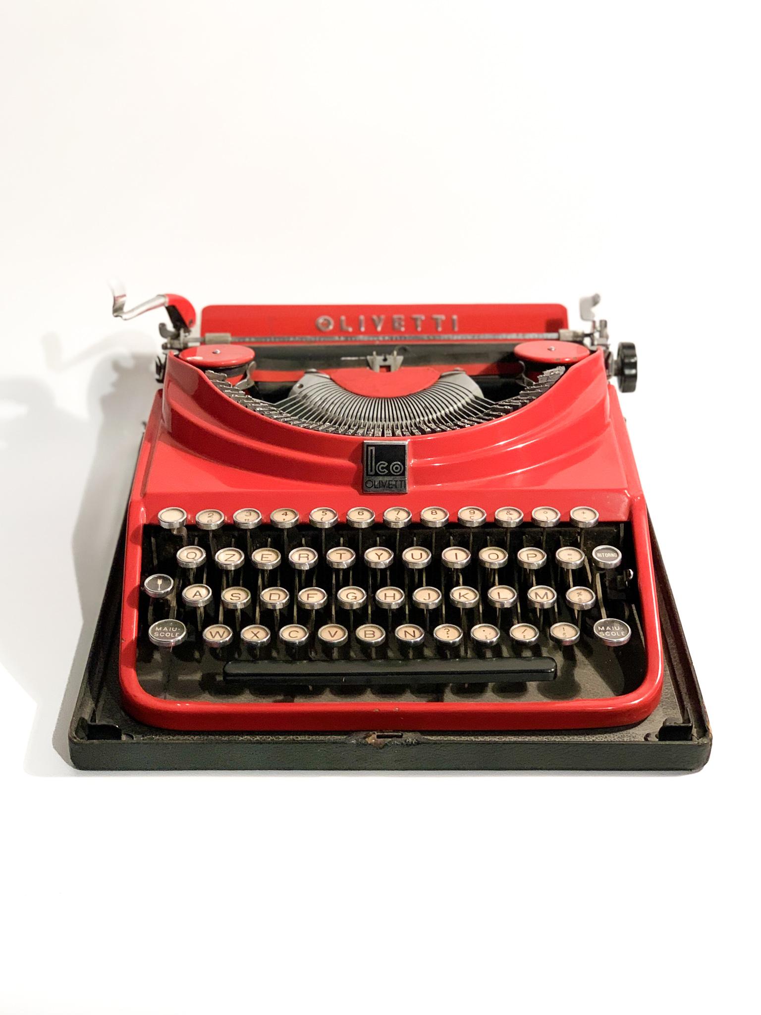 Vintage red typewriter, Olivetti ICO model, in production from 1932 to 1950. 

Thanks to the idea of Adrian Olivetti and Gino Levi Martinaroli, head of the company's Projects and Studies Office at the time, the first Olivetti portable typewriter was
