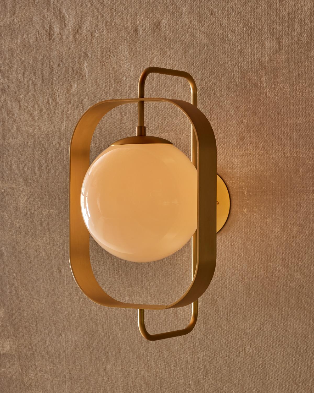 The Olivia sconce has a bench-crafted brass rectangular frame that highlights the glass globe making it the focal point of the fixture.

OVERALL DIMENSIONS
13” W x 14” D x 22.5” H, 10