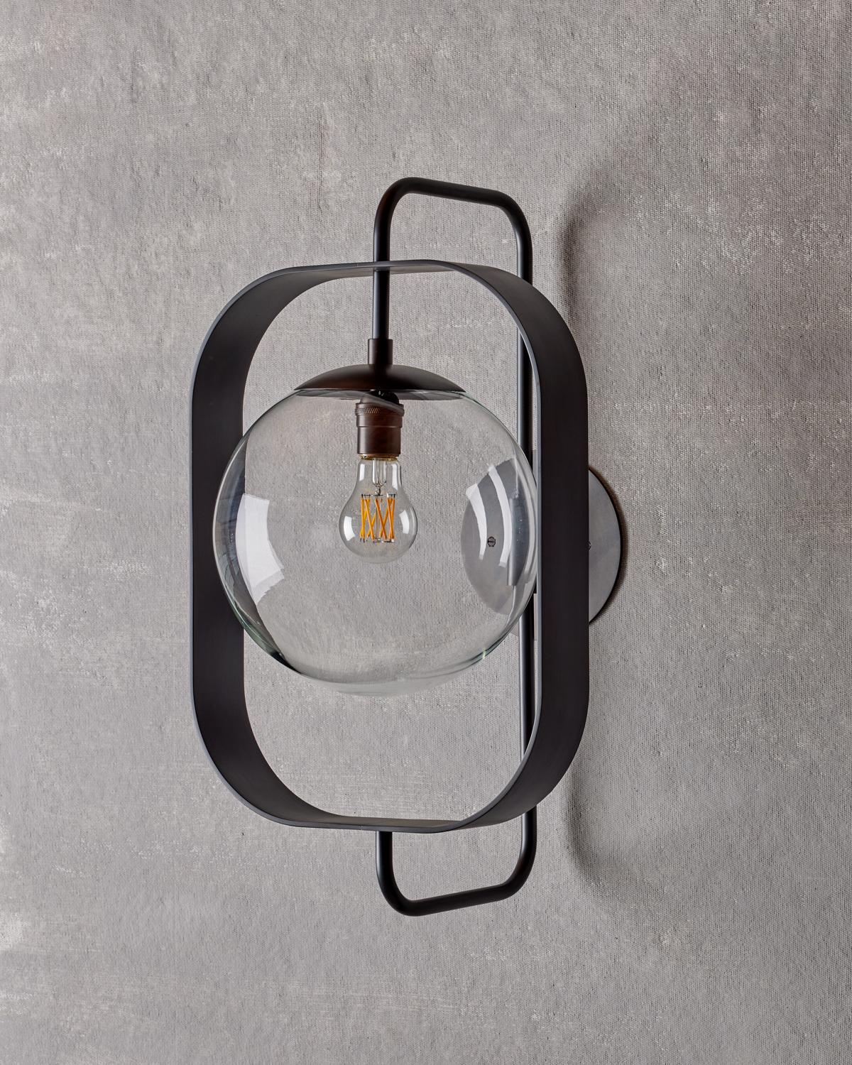 The Olivia sconce has a bench-crafted brass rectangular frame that highlights the glass globe making it the focal point of the fixture.

OVERALL DIMENSIONS
13” W x 14” D x 22.5” H, 10