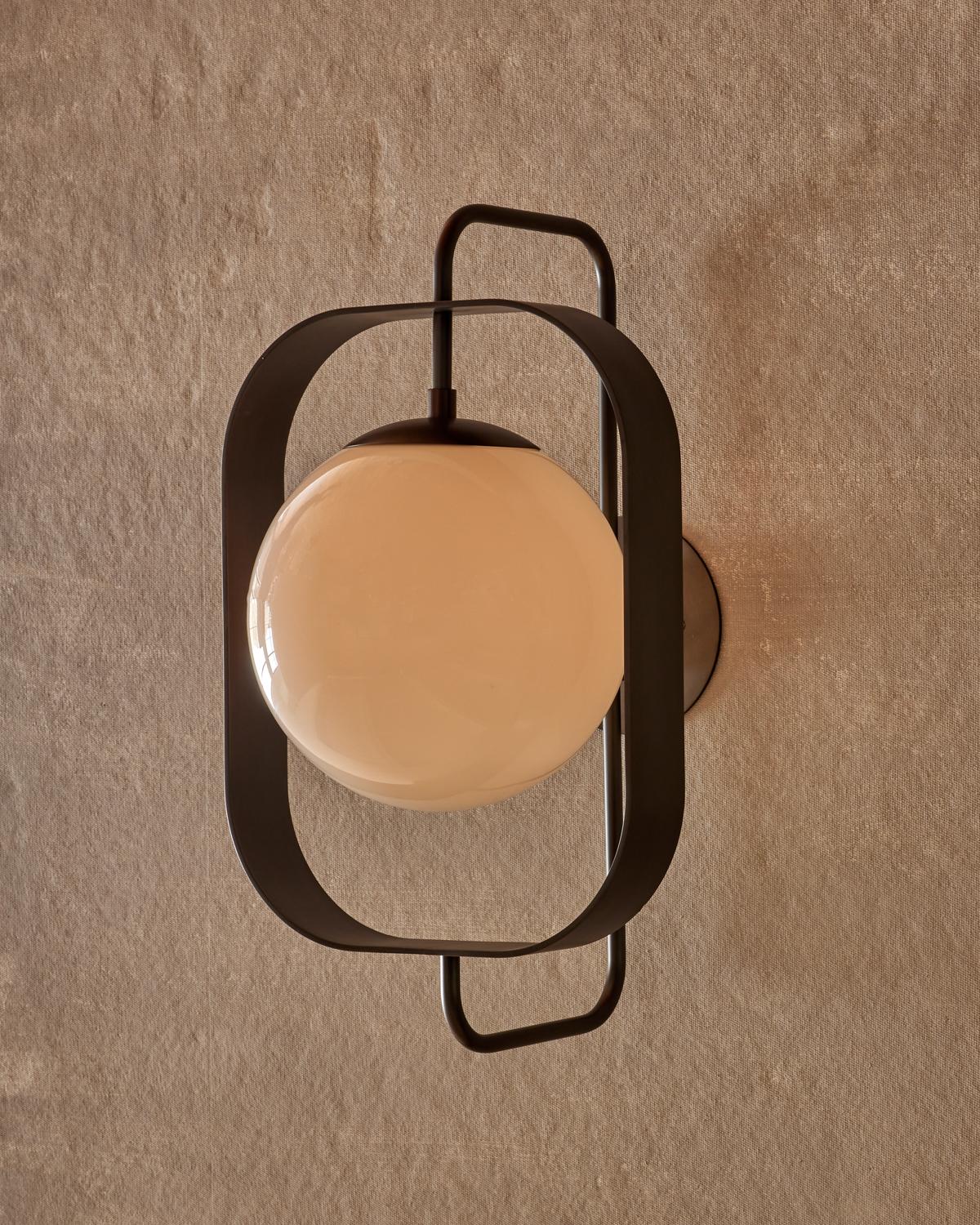 The Olivia sconce has a bench-crafted brass rectangular frame that highlights the glass globe making it the focal point of the fixture.

OVERALL DIMENSIONS
13” W x 14” D x 22.5” H, 10