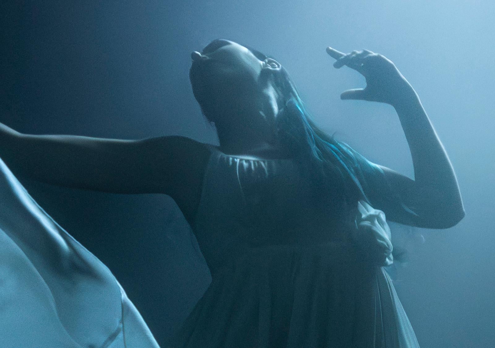 Vanessa into the Blue- Fine art print, Color underwater photography with a model - Photograph by Olivier Borde